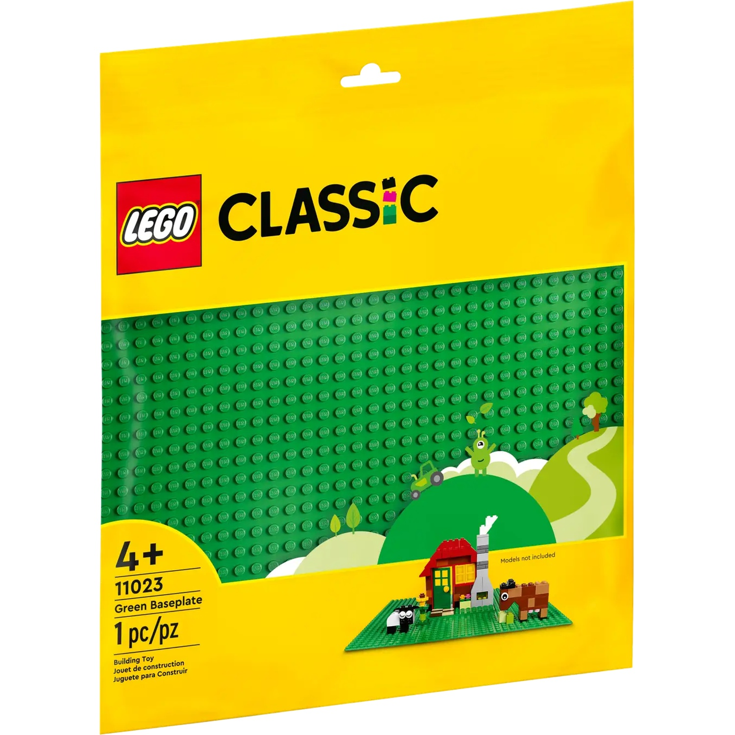 Un sac LEGO Classic jaune avec une plaque de base verte. Il y a une petite scène LEGO avec une maison, des animaux et des arbres.