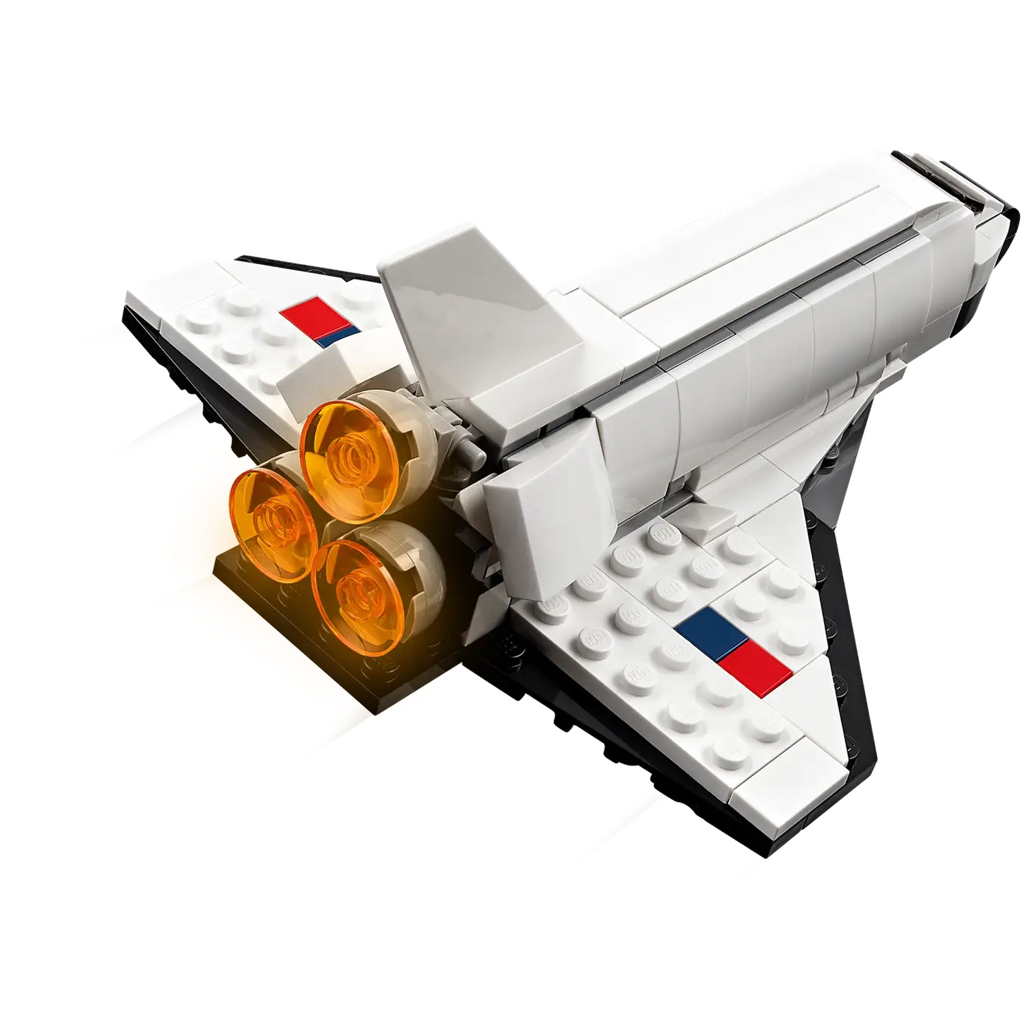 A Lego space shuttle model. It is white with black accents and has orange engine lights. There are red and blue details.