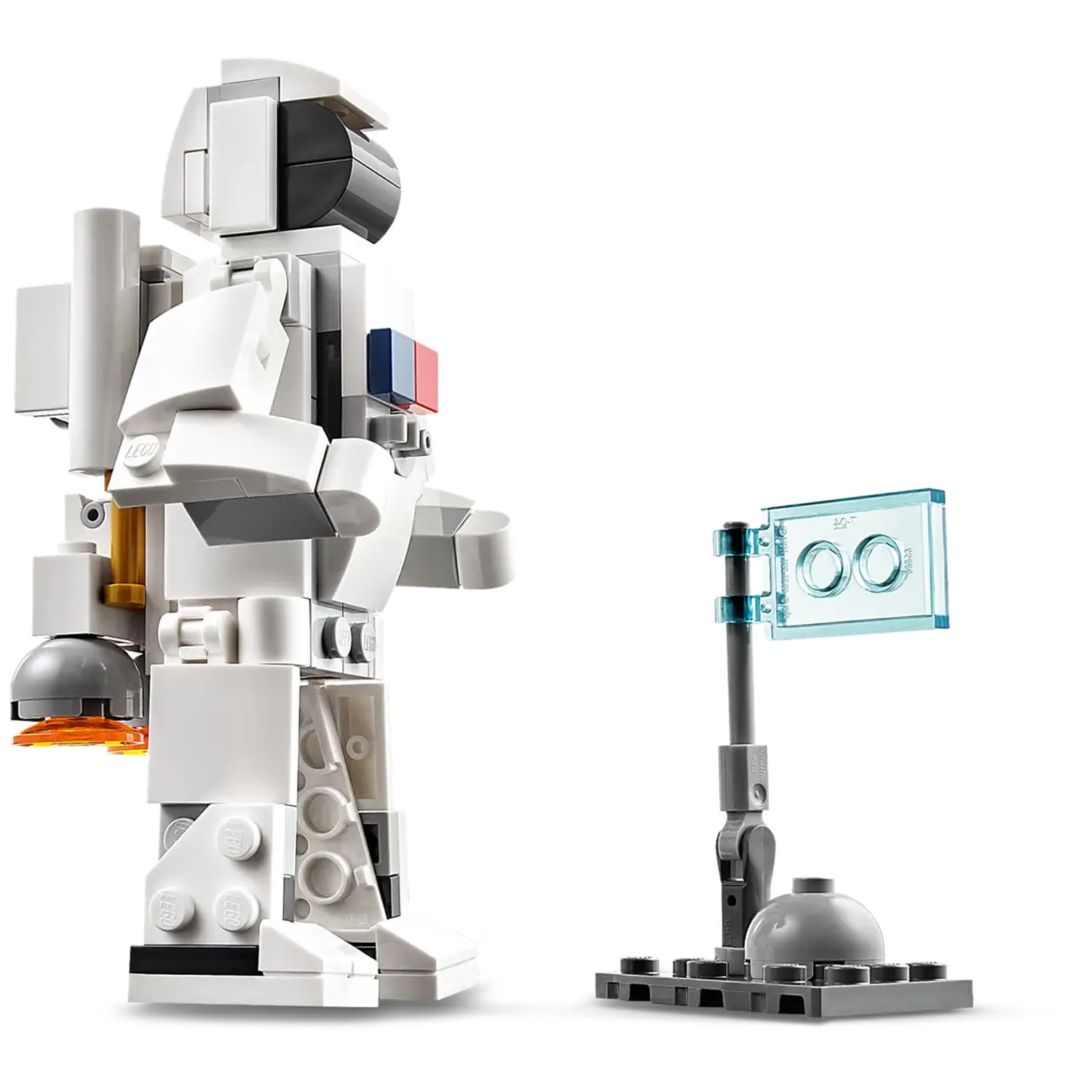 A Lego astronaut stands next to a flag. The astronaut is mostly white with gray and black details. The flag is clear blue.
