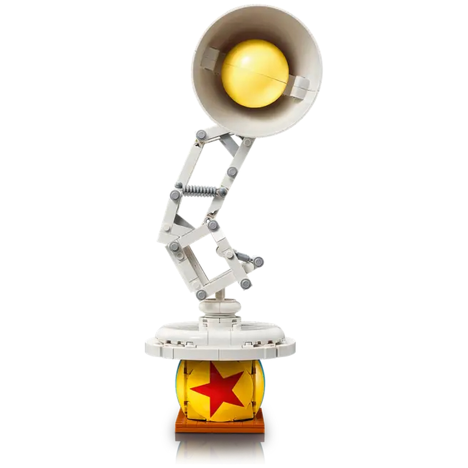 A Lego model of the Pixar lamp. It has a white body, a yellow light bulb, and a base that resembles the Pixar ball.