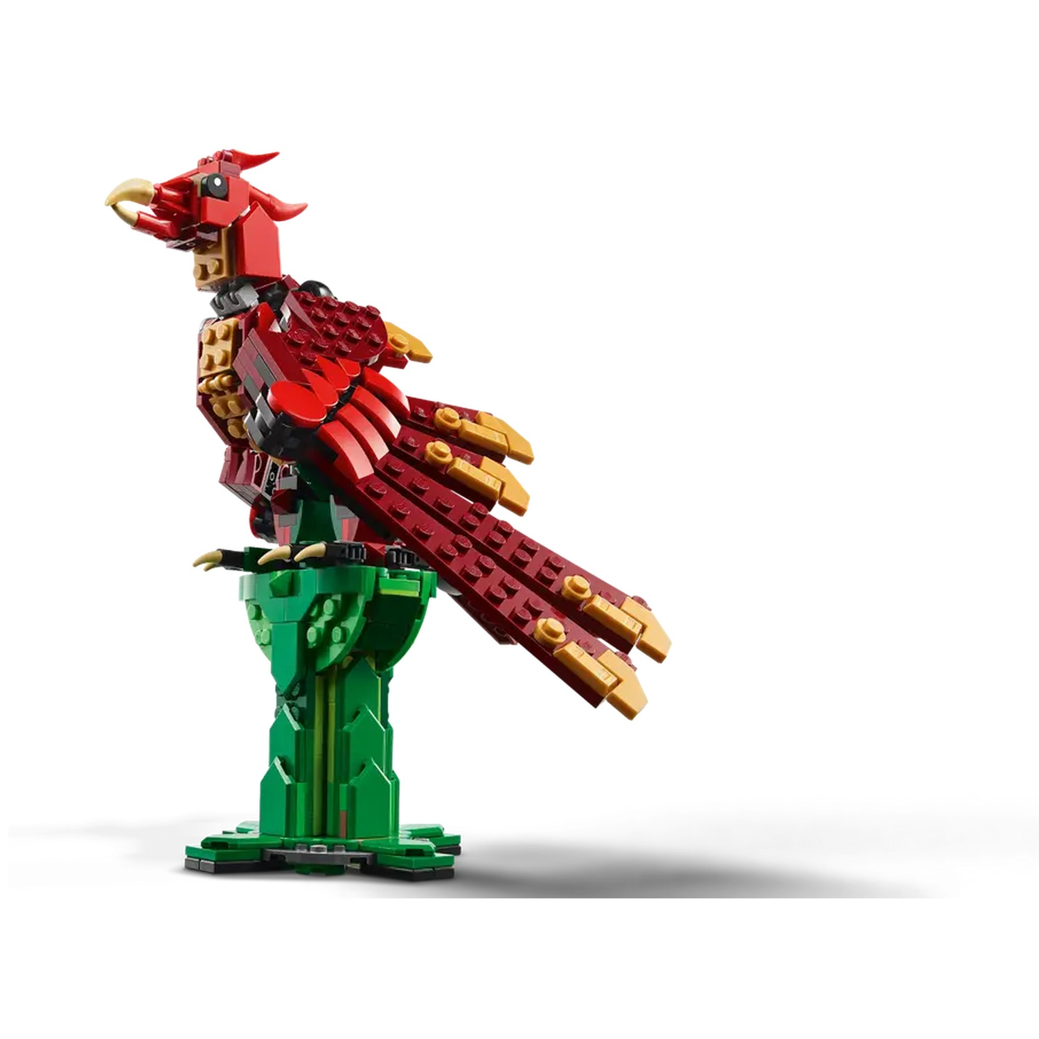 A Lego phoenix with red, gold, and green blocks. It stands on a green stand against a white background.