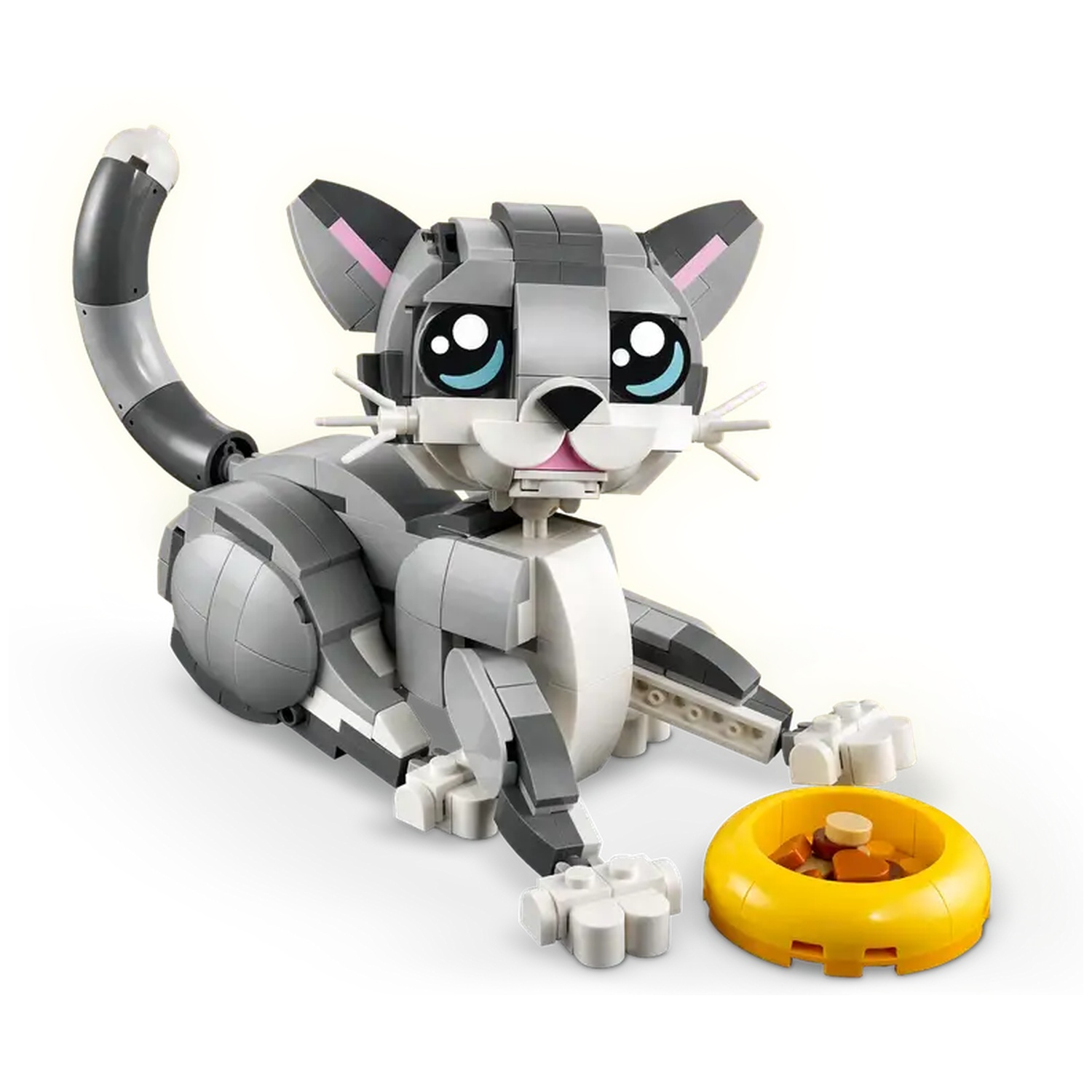 A Lego cat is laying down. It is gray and white. It has a yellow bowl with food. The background is white.