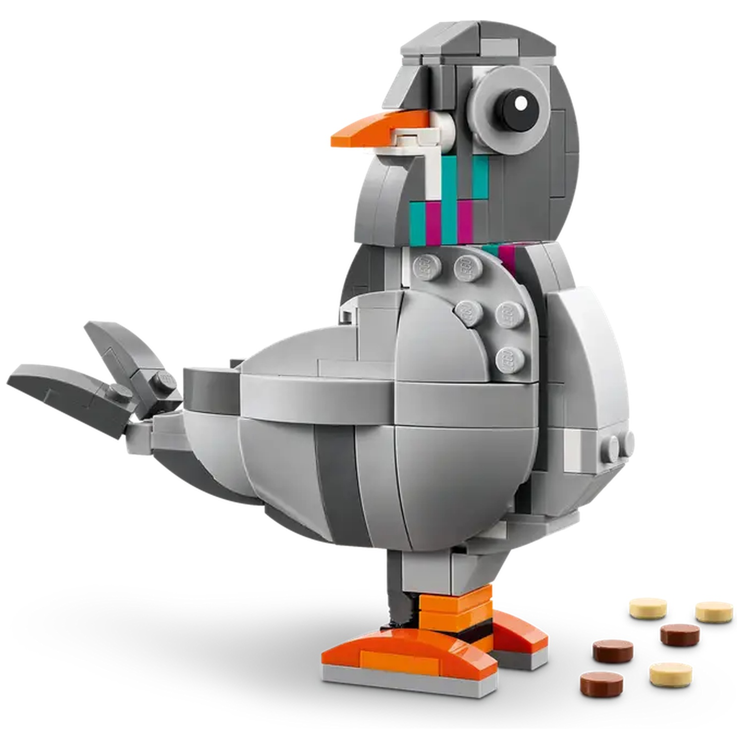 A Lego pigeon stands on a white surface. It is gray, with an orange beak and legs. Small brown and tan circles are at its feet.