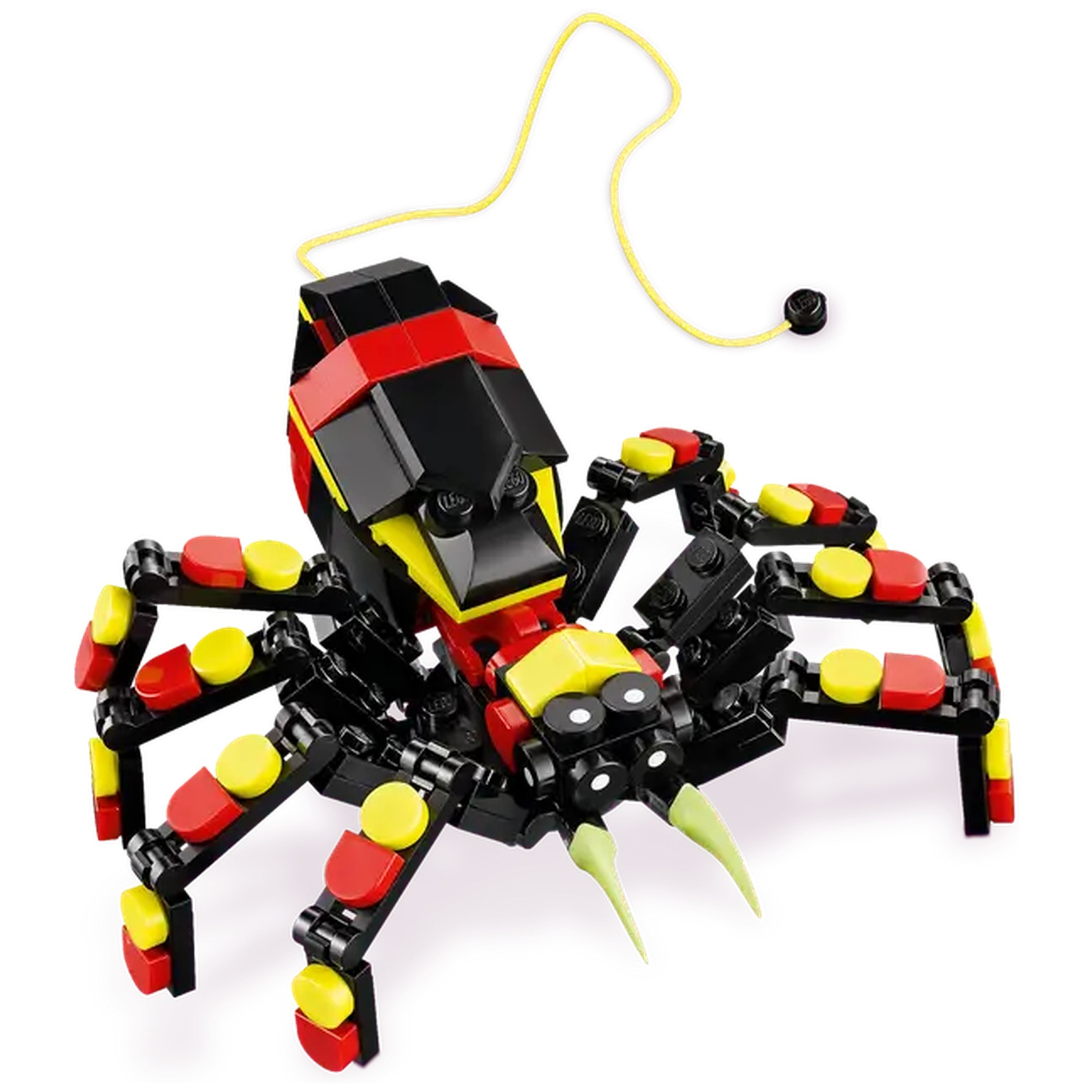 A Lego spider toy, black, red, and yellow, with green pincers and a yellow string attached to it, on a white background.