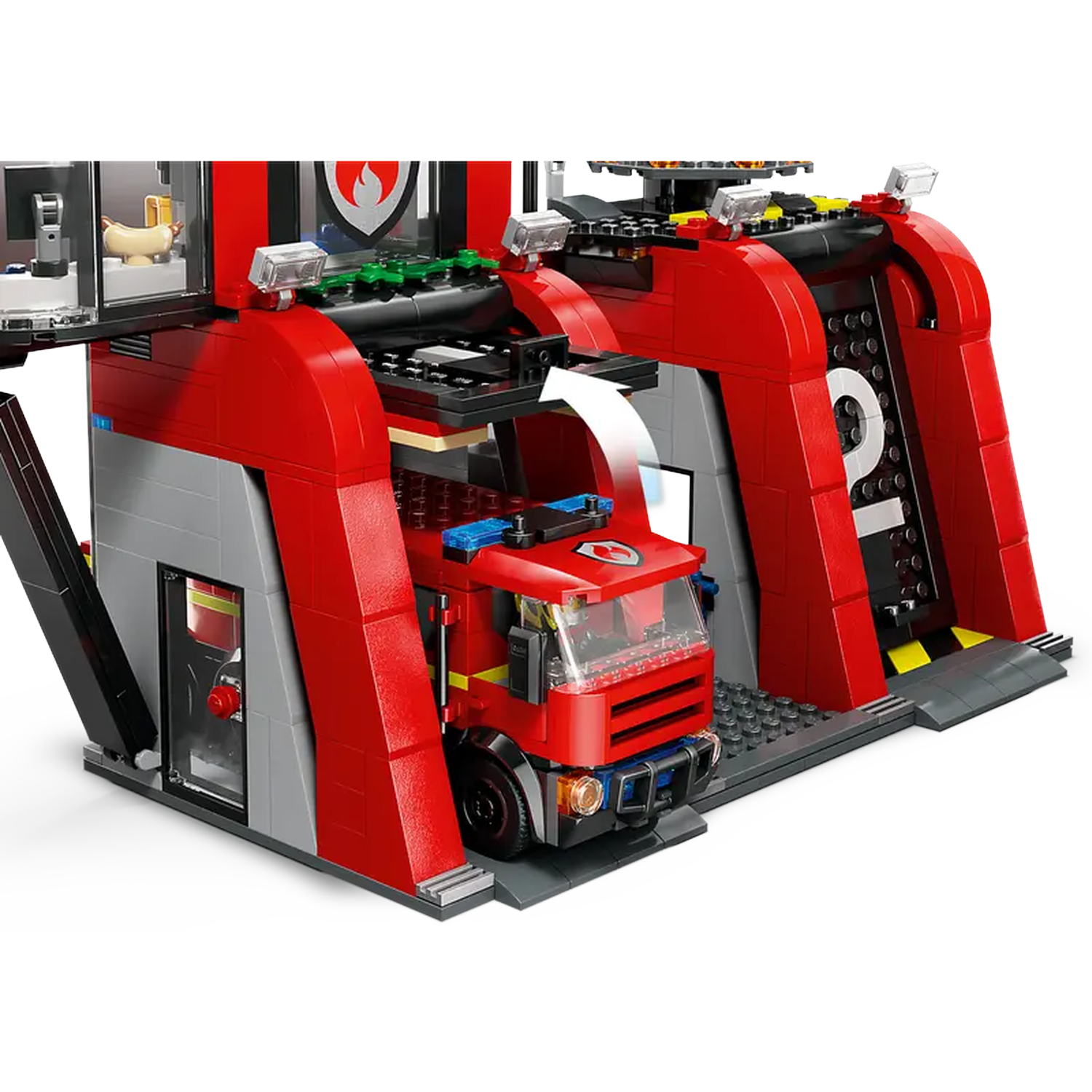 A Lego fire station with a red fire truck inside. The station has red and gray walls. A small hotdog is inside.