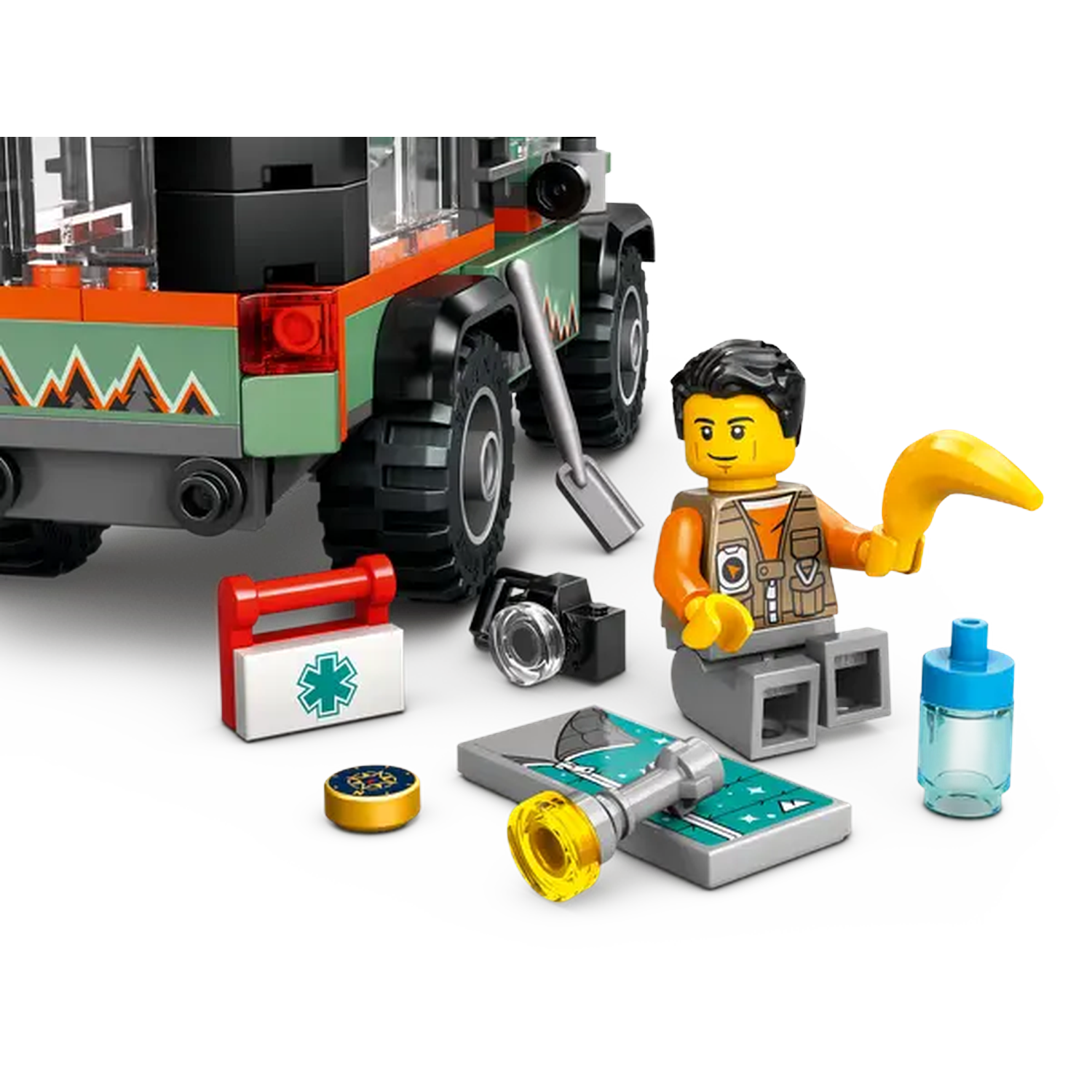 Lego set with a green and orange jeep, a minifigure, medical kit, camera, and other accessories on a white surface.