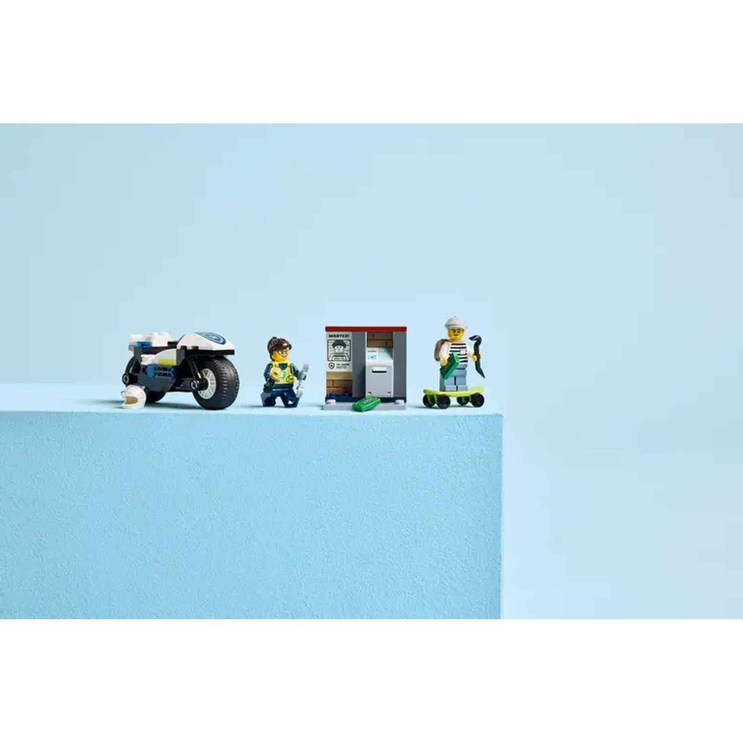 Lego set with a police motorcycle, a wanted poster, a woman with a tool and a man on a skateboard.