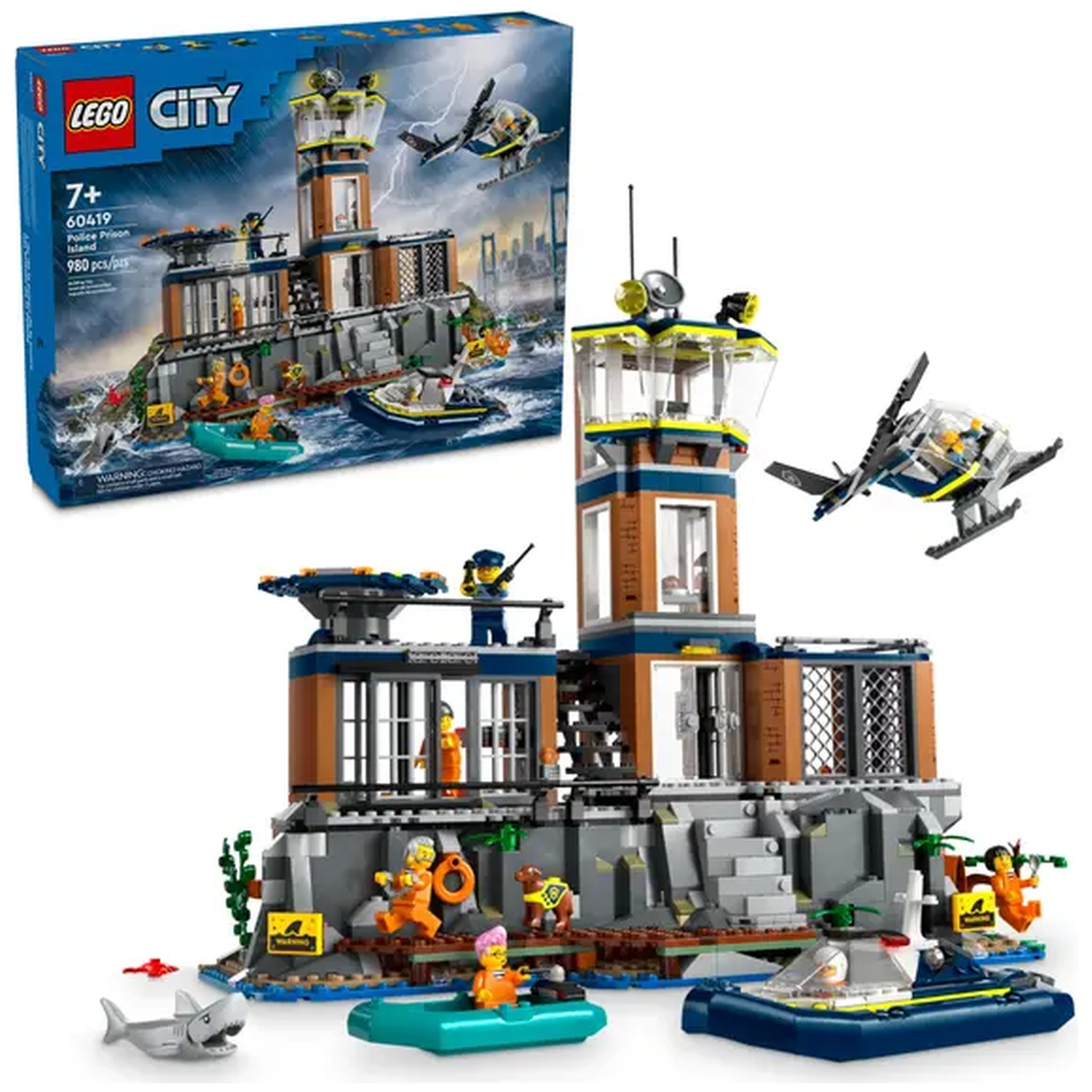Ensemble Lego City Police Prison Island. Comprend prison, hélicoptère, bateaux, figurines et requin. La boîte est en haut à gauche.