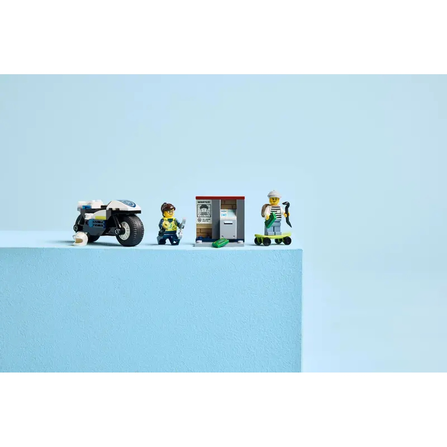 Lego set with a police motorcycle, a wanted poster, and two minifigures, one on a skateboard.