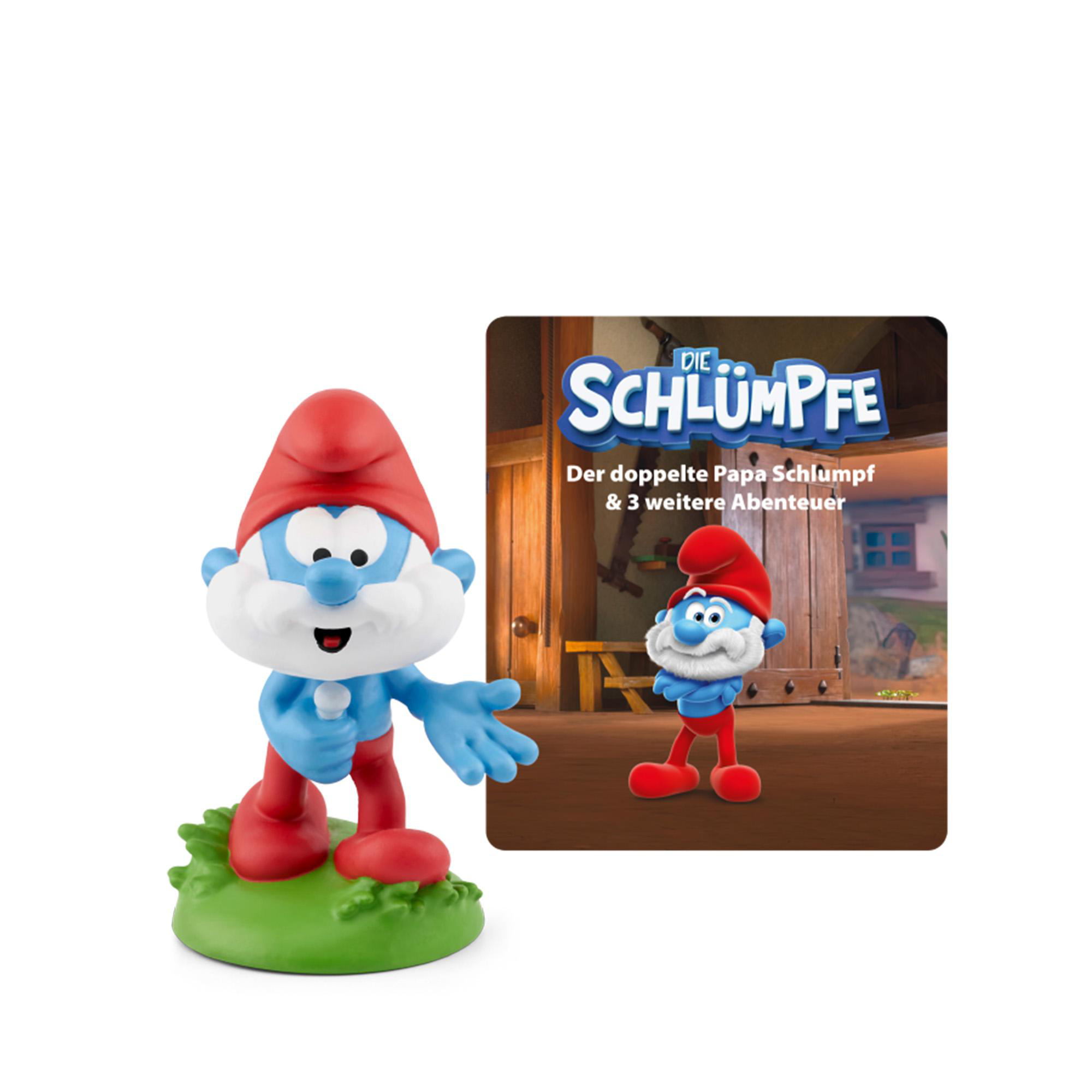 Eine Schlümpfe-Figur mit roter Mütze und blauer Haut steht auf grünem Gras. Daneben ein Bild von Papa Schlumpf.