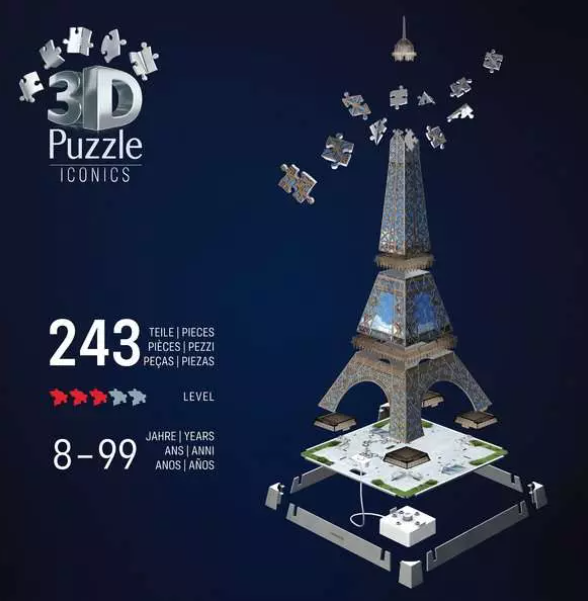 Ein 3D-Eiffelturm-Puzzle mit verstreuten Teilen. Es hat 243 Teile, für das Alter von 8-99 Jahren. Der Hintergrund ist dunkelblau.