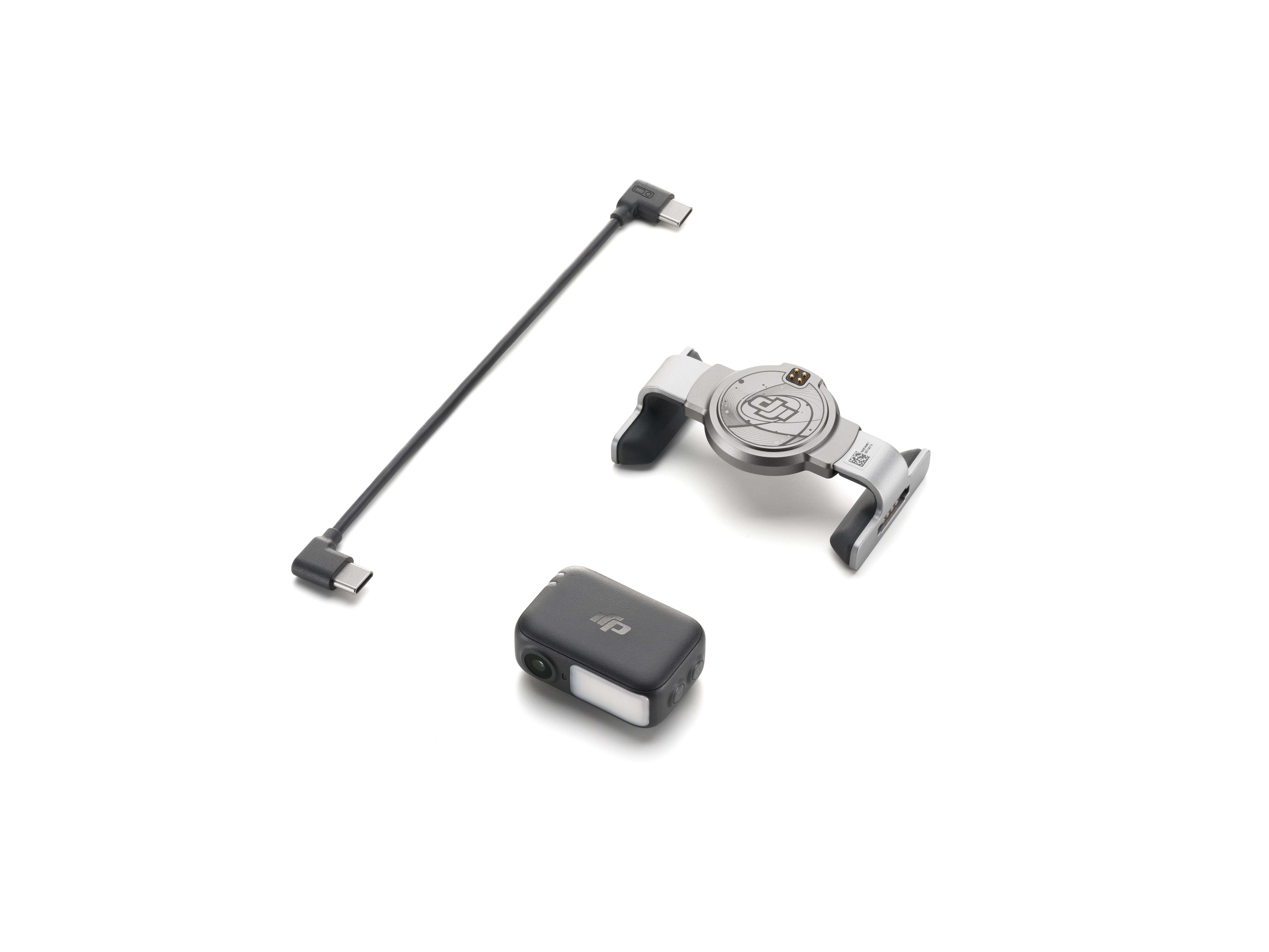 Drei elektronische Geräte auf weißem Hintergrund: ein Kabel, ein Gerät mit Griffen und eine kleine schwarze Kamera.