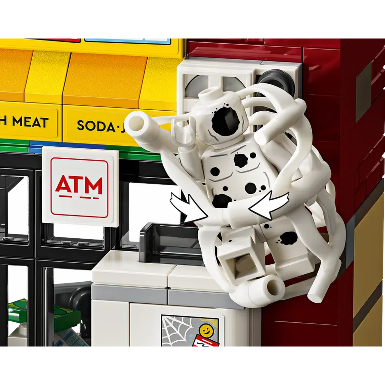 A Lego figure with white and black spots, arms outstretched, in front of a building with signs for ATM and soda.
