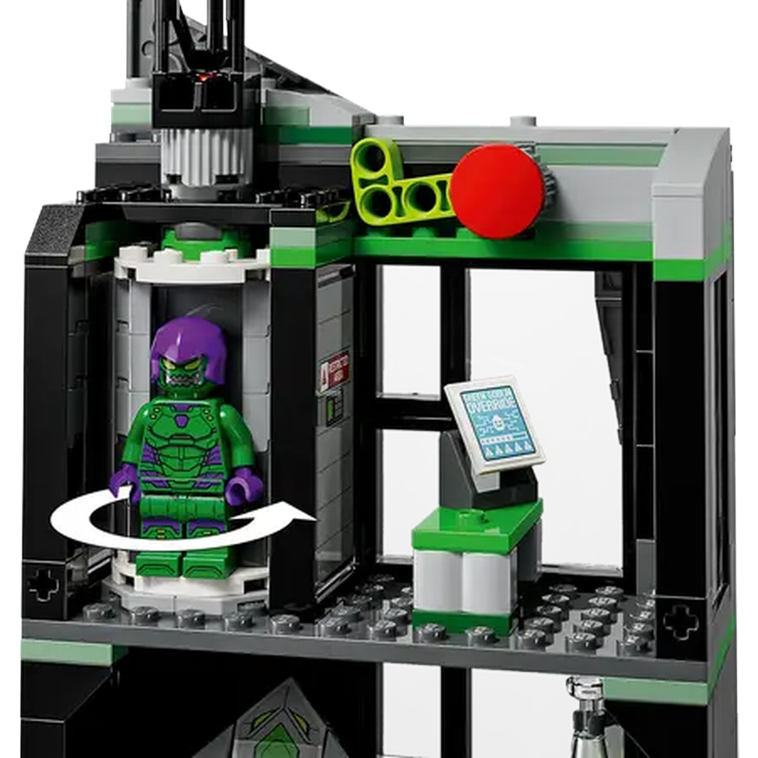 Lego set depicting a green and purple villain with a building. Features include a red button, and a control panel.