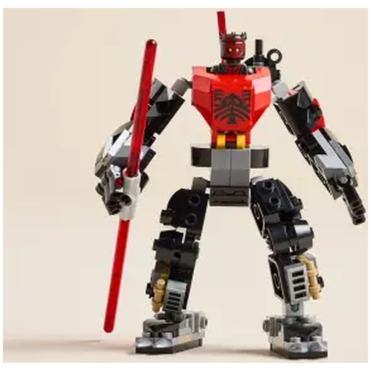 A Lego robot figure with a red lightsaber. It has a red torso, black legs, and gray arms. The background is cream.