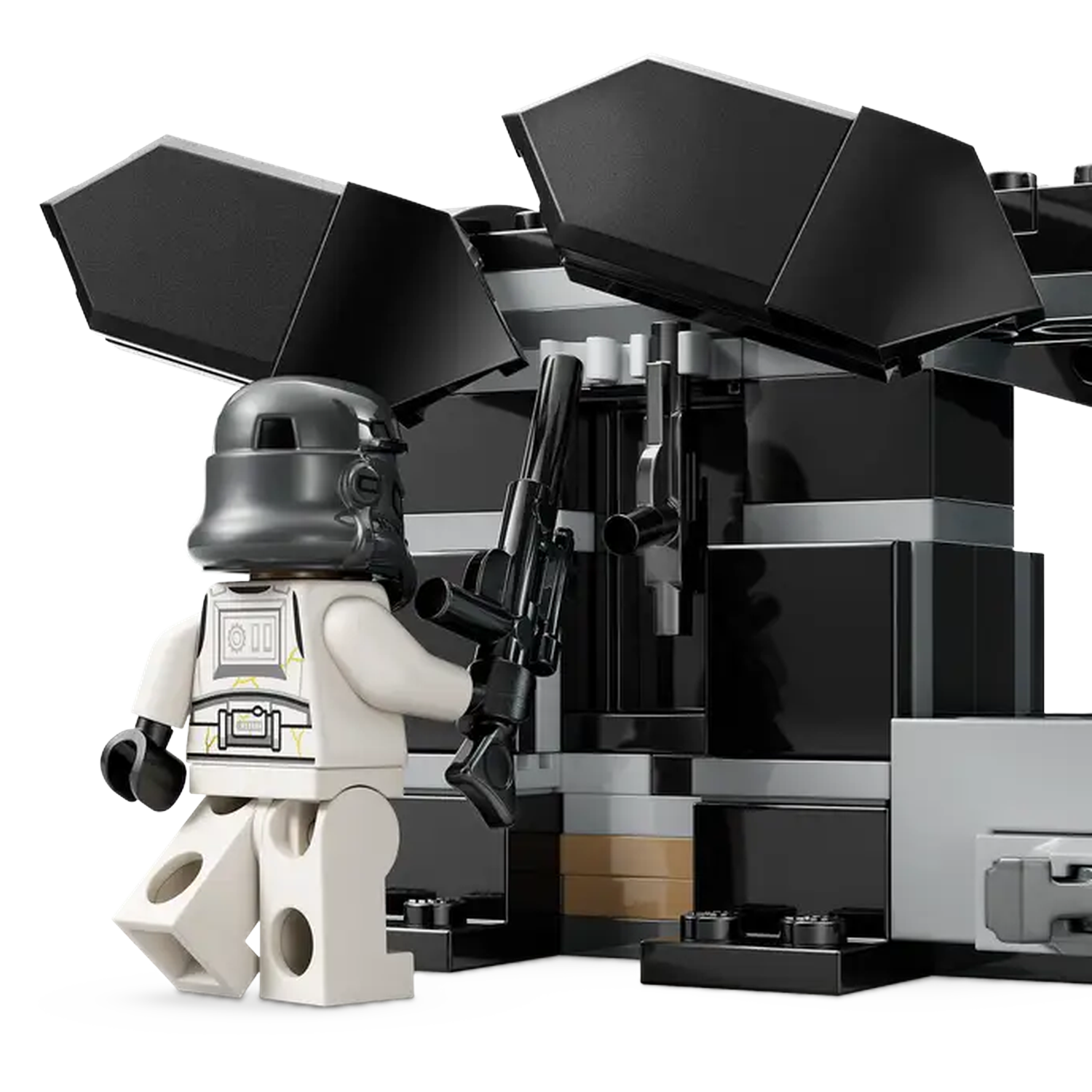 A white Lego figure with a black helmet and weapon stands before a black and gray structure.
