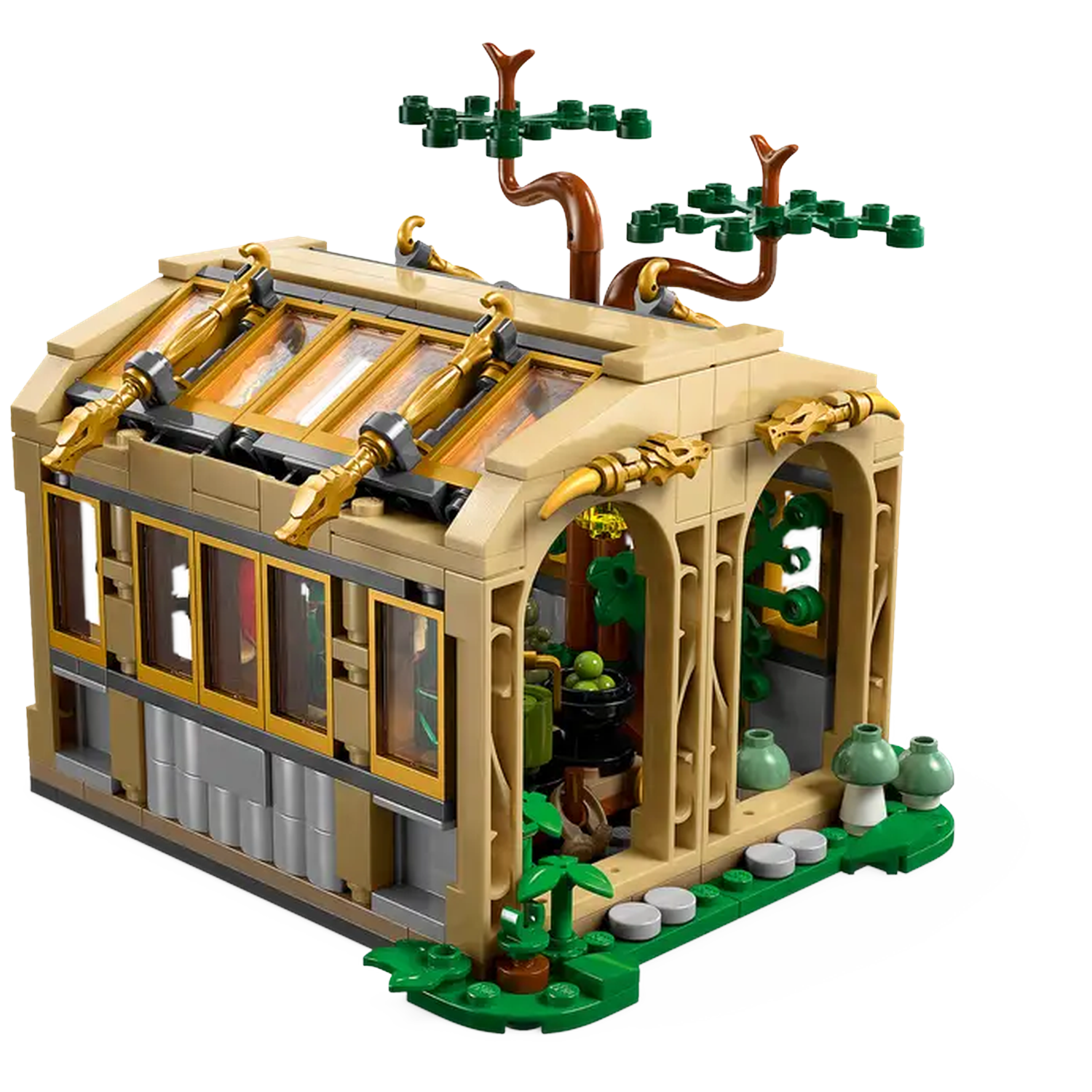 A Lego greenhouse model. It features a beige structure with gold accents, windows, a tree, and green plant elements.