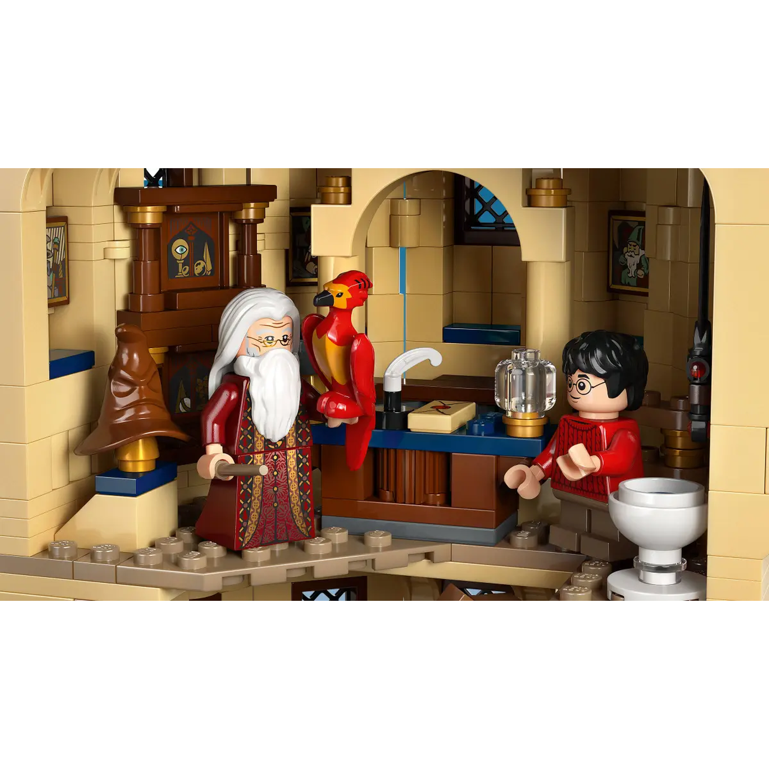 Lego scene of Dumbledore, Harry Potter, and Fawkes.  Dumbledore holds a wand. Harry stands near a glass container. A phoenix sits on a desk.