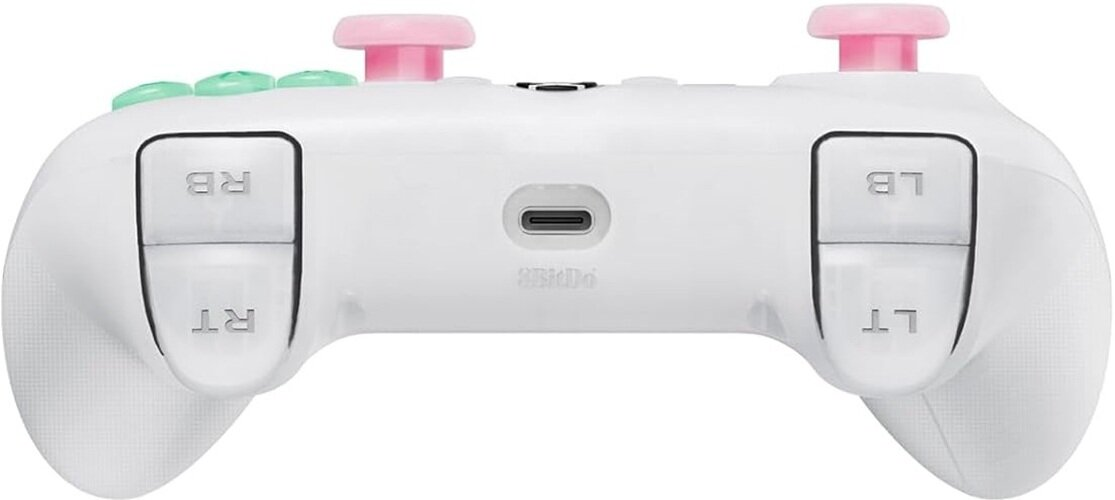 Biały kontroler do gier z różowymi i zielonymi przyciskami, różowymi drążkami i opisanymi przyciskami barkowymi.