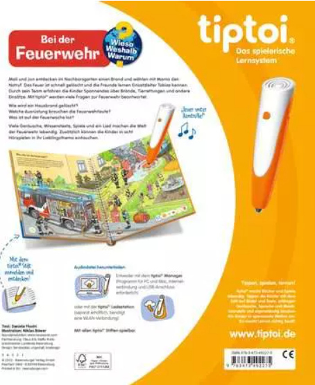 Ein offenes Buch mit Illustrationen eines Feuerwehrautos und Feuerwehrleuten. Es gibt zwei orangefarbene Stifte. Der Text lautet 'Feuerwehr'.