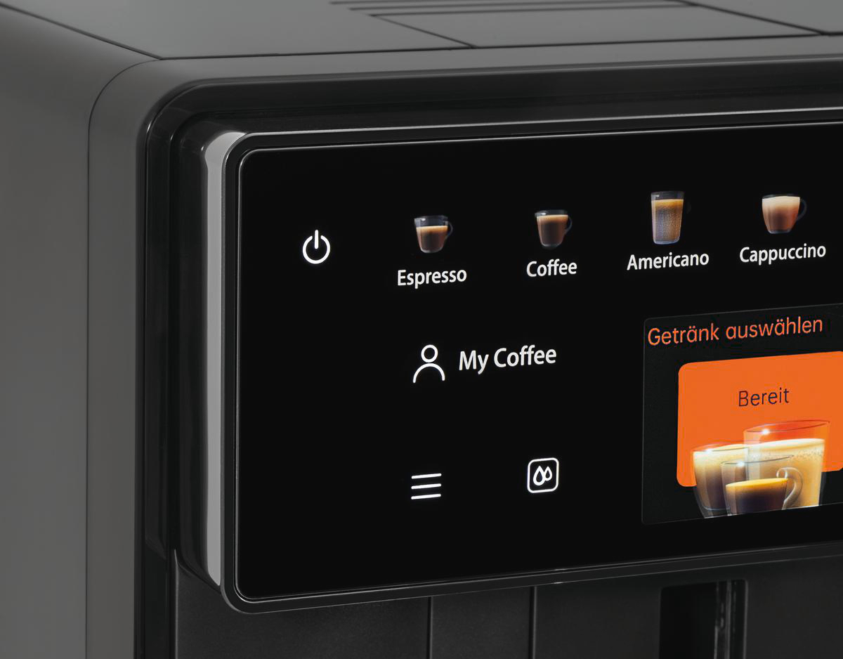 Kaffeemaschinen-Display mit Optionen: Espresso, Kaffee, Americano, Cappuccino. 'Getränk auswählen' und 'Bereit' sind ebenfalls sichtbar.