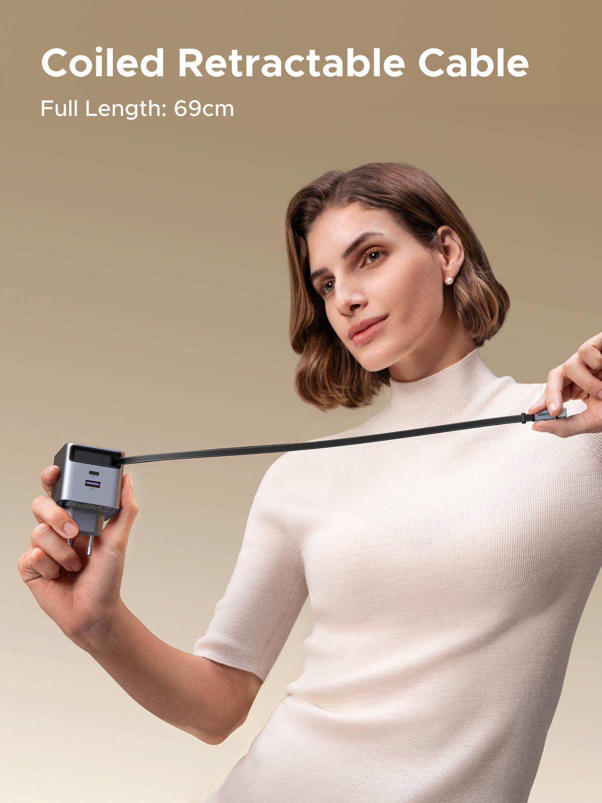 Frau hält ein schwarzes, einziehbares Kabel mit einem Ladegerät. Oben steht: Coiled Retractable Cable. Länge: 69cm.