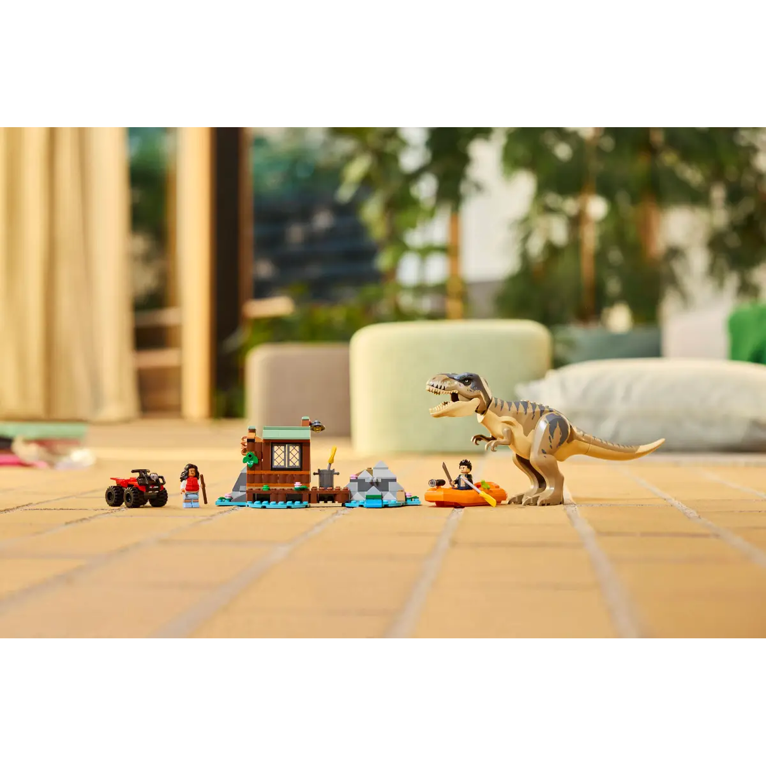 A Lego set shows a T-Rex, a boat, a cabin, a quad bike, and two figures on a brick floor, with green foliage in the background.