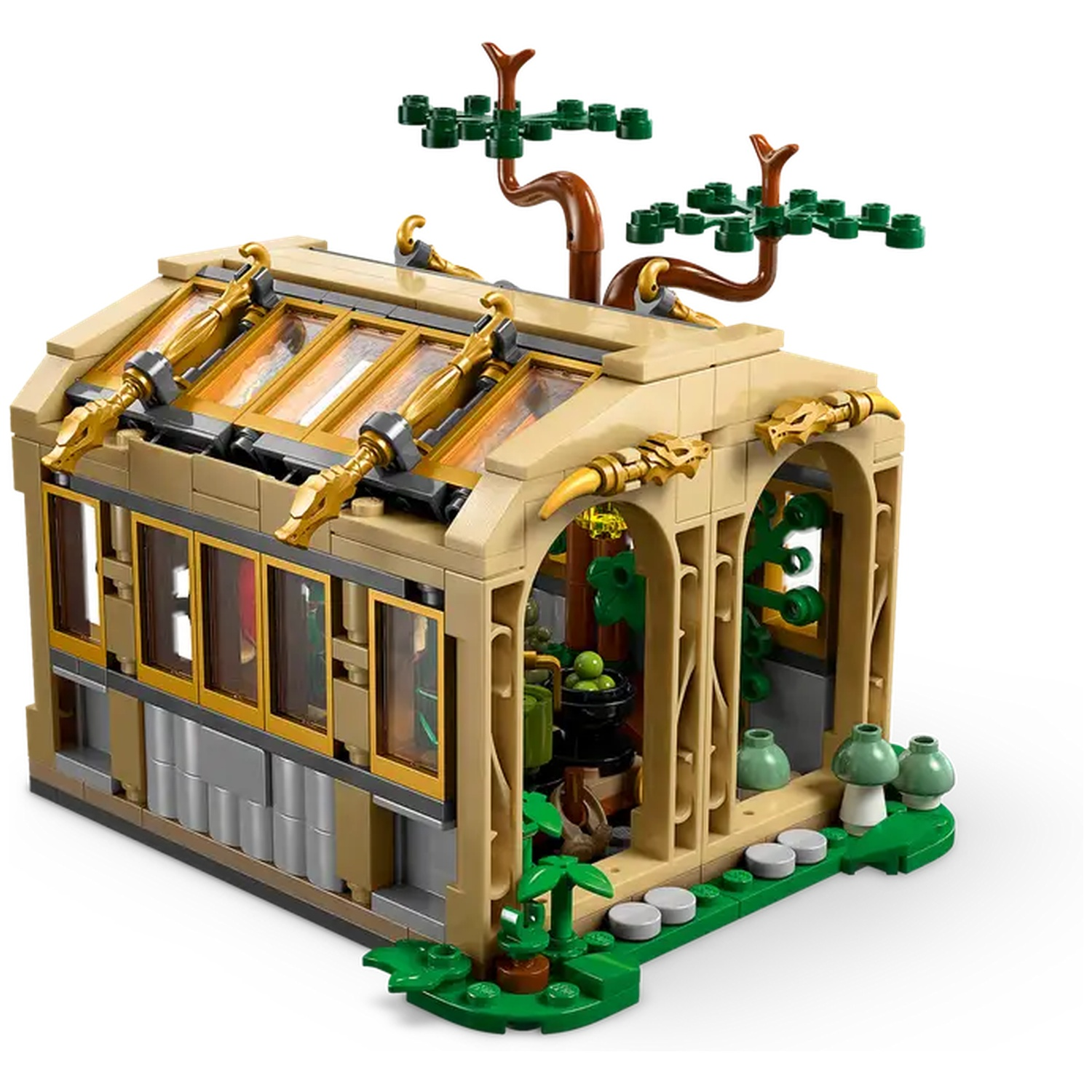 A Lego model of a tan and gold greenhouse with dragon details. Green plants, mushrooms, and trees are outside. The roof has glass panels.