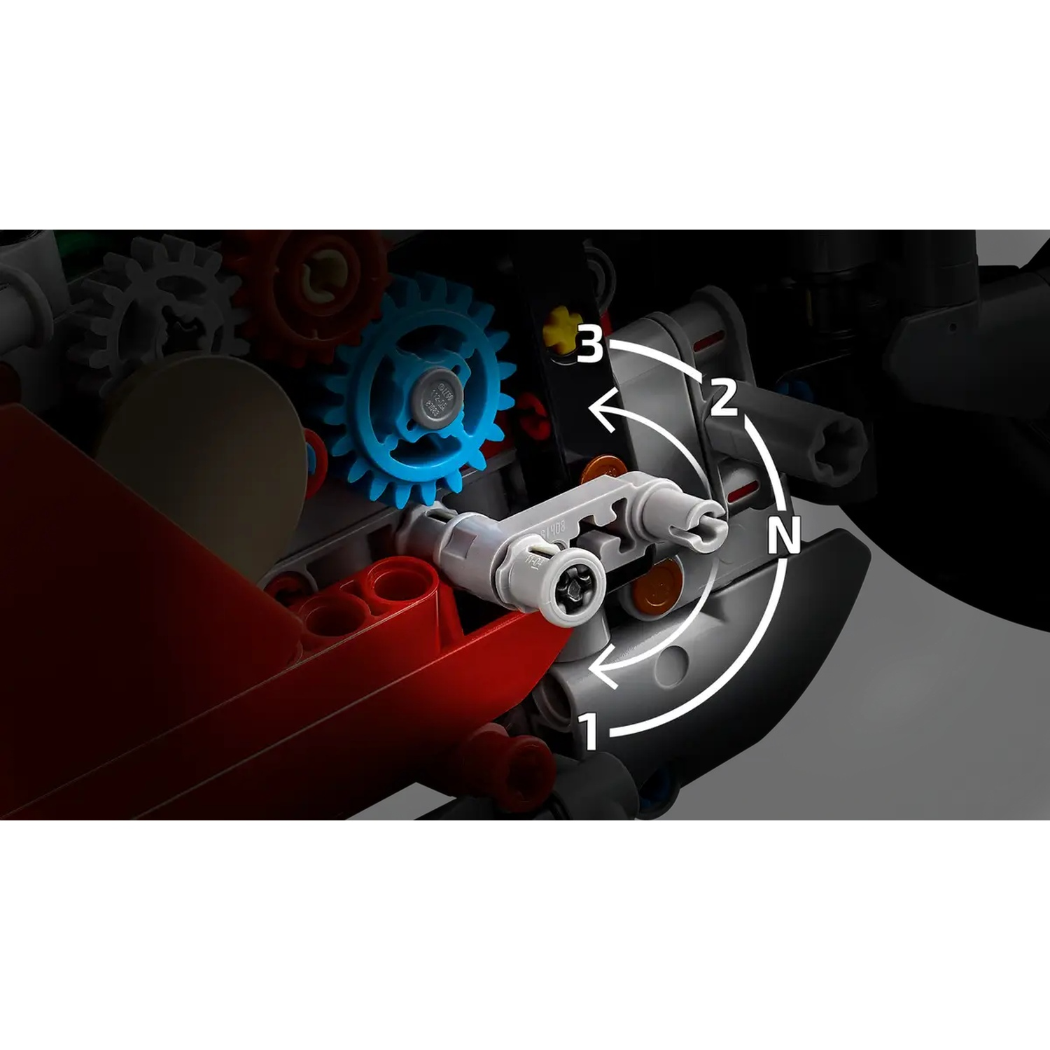 Gros plan sur des engrenages Lego. Des engrenages bleus, rouges et blancs sont visibles. Des flèches pointent vers différentes positions sur un composant gris.