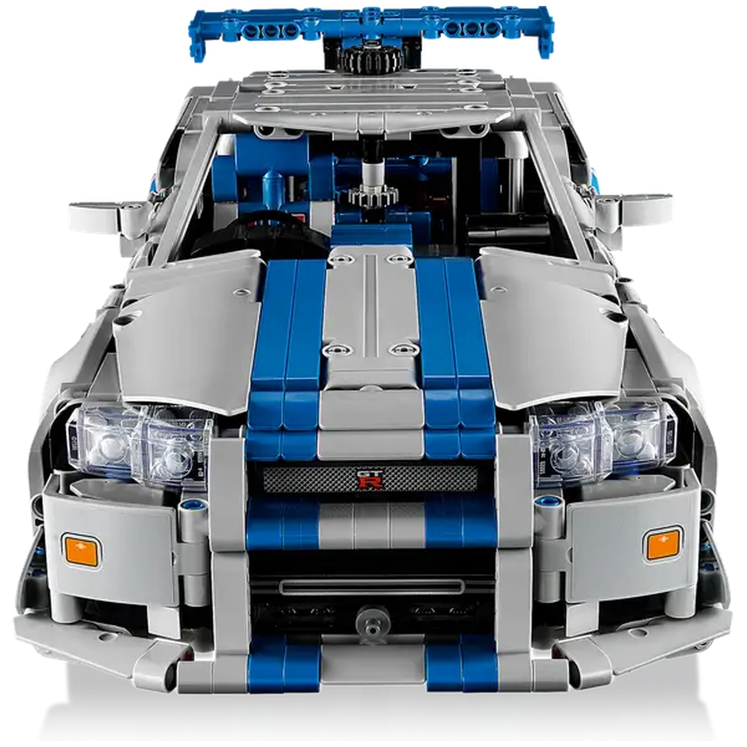 A Lego car model. It is silver and blue. The car has headlights, a spoiler, and a detailed interior. The background is white.