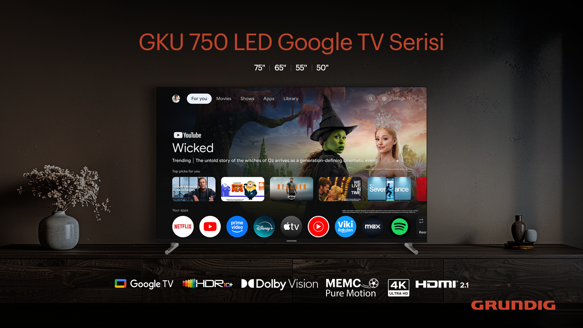 Bir TV, Wicked ile YouTube uygulamasını gösteriyor. Aşağıda Netflix, Disney+ vb. gibi uygulama simgeleri var. TV ahşap bir sehpada duruyor.