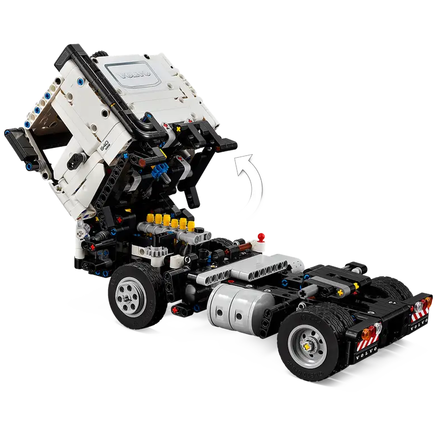 A Lego Technic Volvo truck model. The cabin is raised, showing engine details. The truck is mostly black and white with gray wheels.