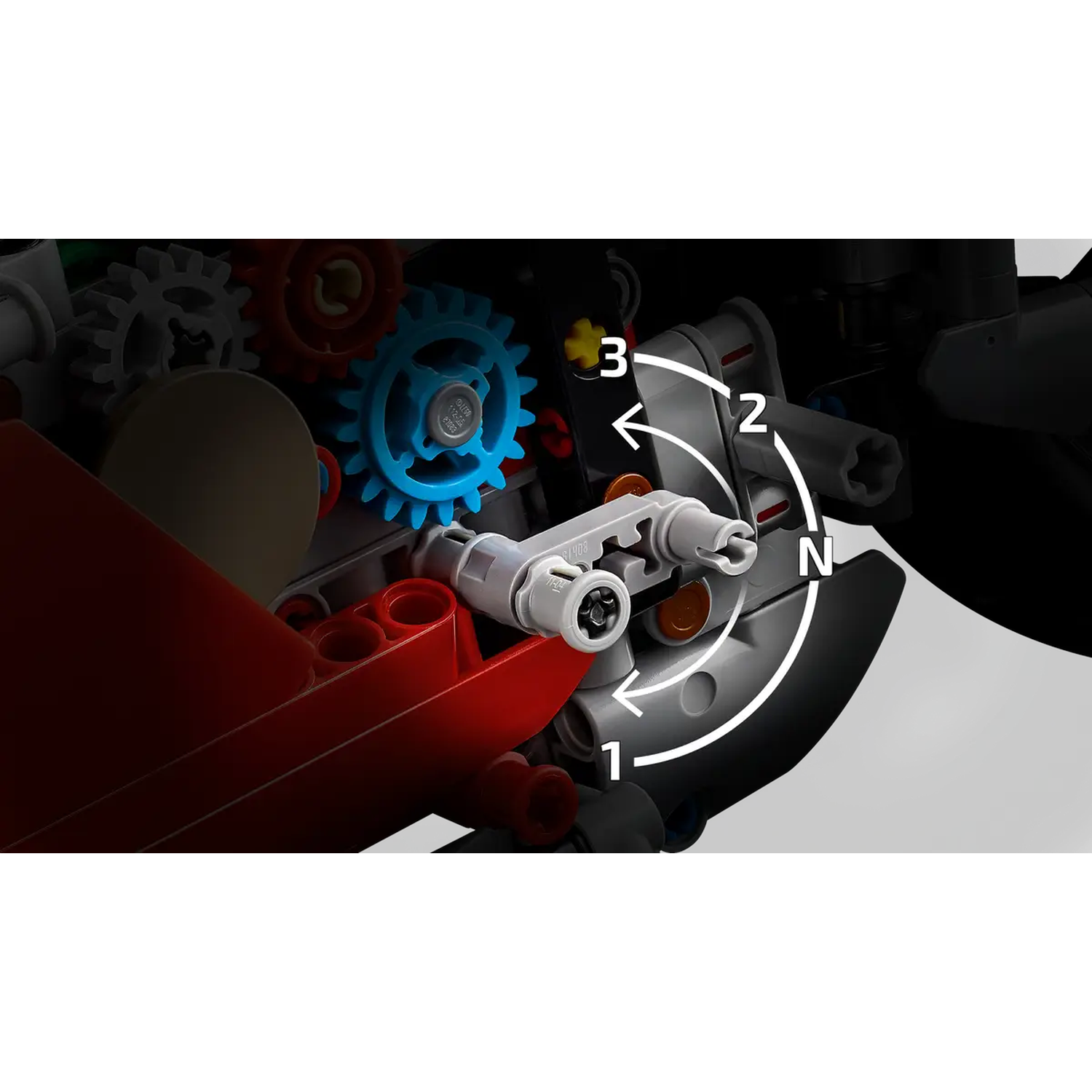 Close-up of Lego Technic gears. A blue gear is in the center, with a red piece on the left and a black background. Numbers 1, 2, 3 and N are shown.
