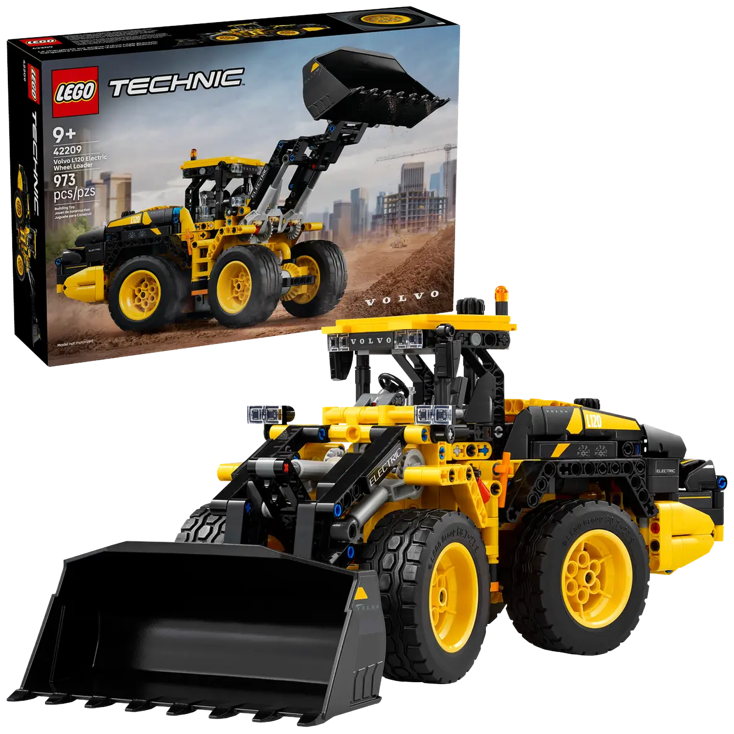 A Lego Technic Volvo L120 Electric Wheel Loader. It is yellow and black. The box is in the background. The background shows a construction site.