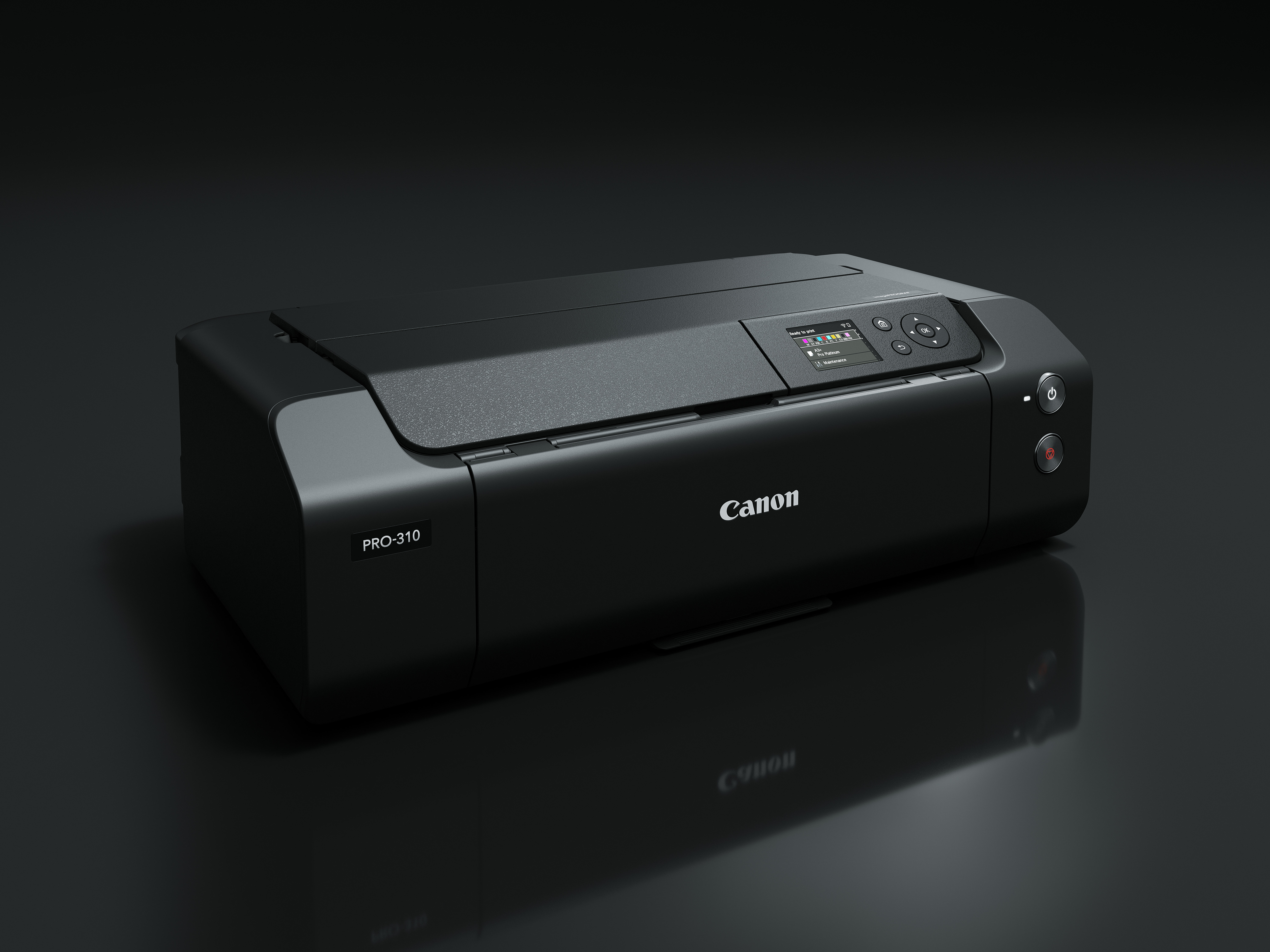 Ein schwarzer Canon Pro-310-Drucker auf dunkler Oberfläche. Er zeigt einen Bildschirm, Power- und andere Bedienelemente.