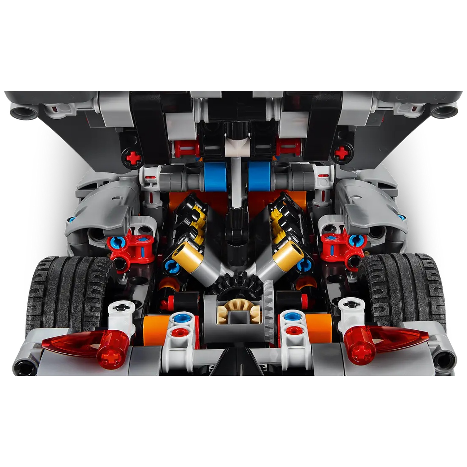 A detailed Lego Technic car model. Visible are tires, engine details with yellow, blue, and red elements, and a black spoiler.