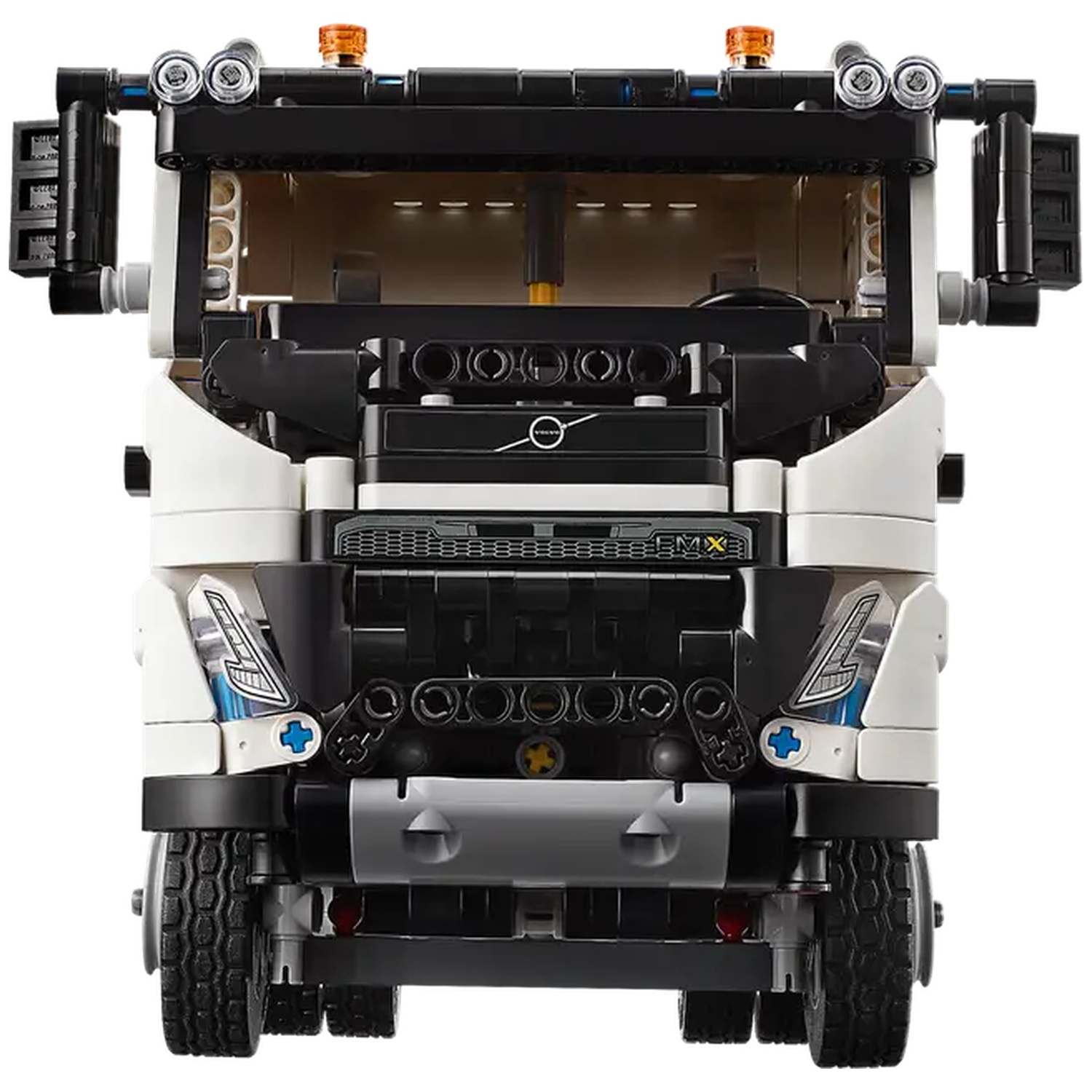 A Lego truck model, primarily black and white with gray accents. Features headlights, wheels, and orange lights on top. Volvo logo visible.