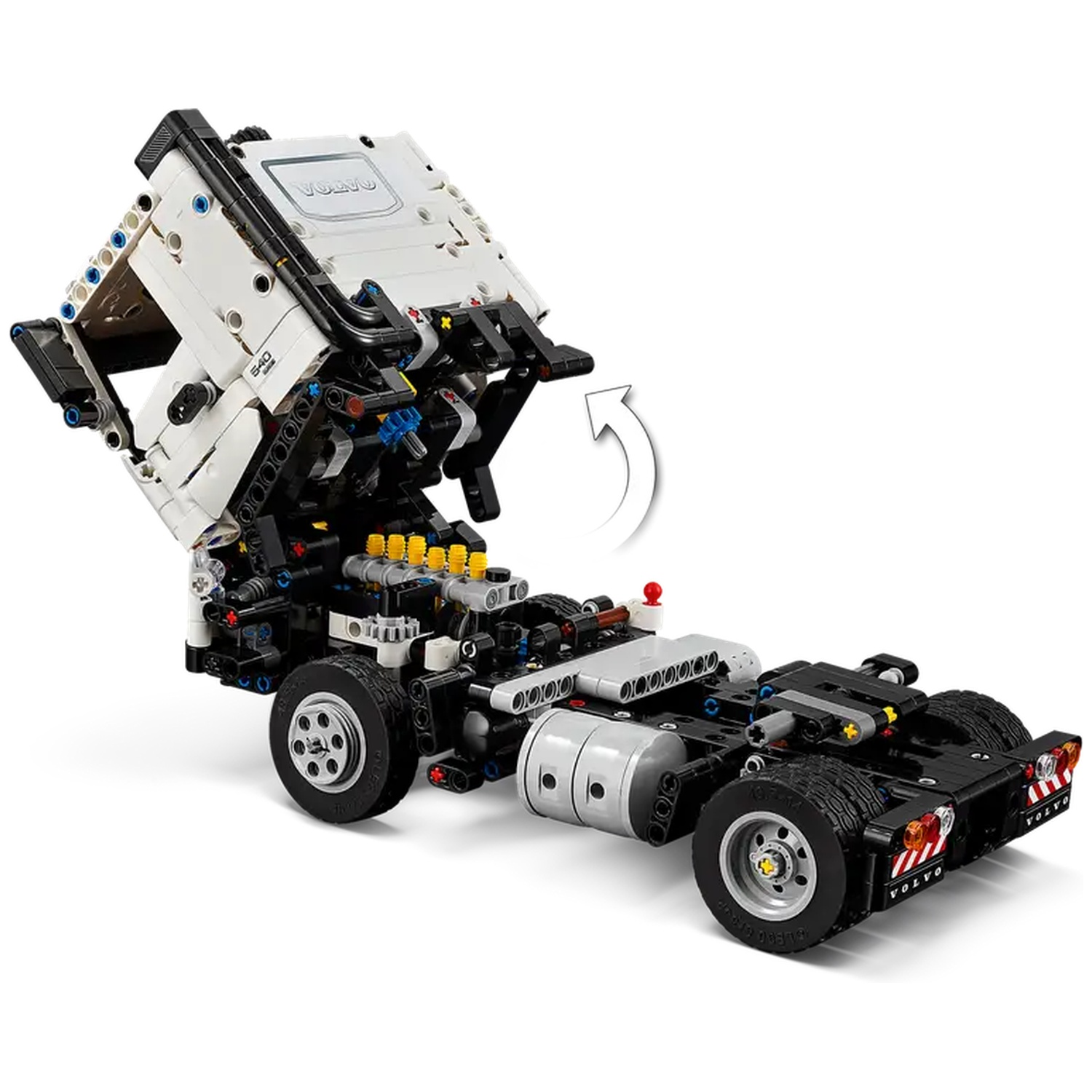 A Lego Technic Volvo truck model. The cab is raised, revealing the engine. The truck is mostly black and white with details.