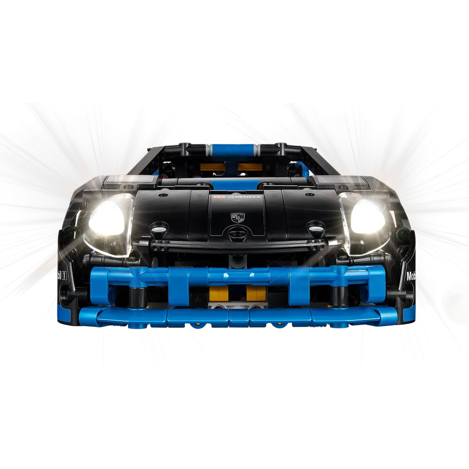 Front view of a black and blue toy sports car with headlights on. The car has a Porsche logo and is on a white background.