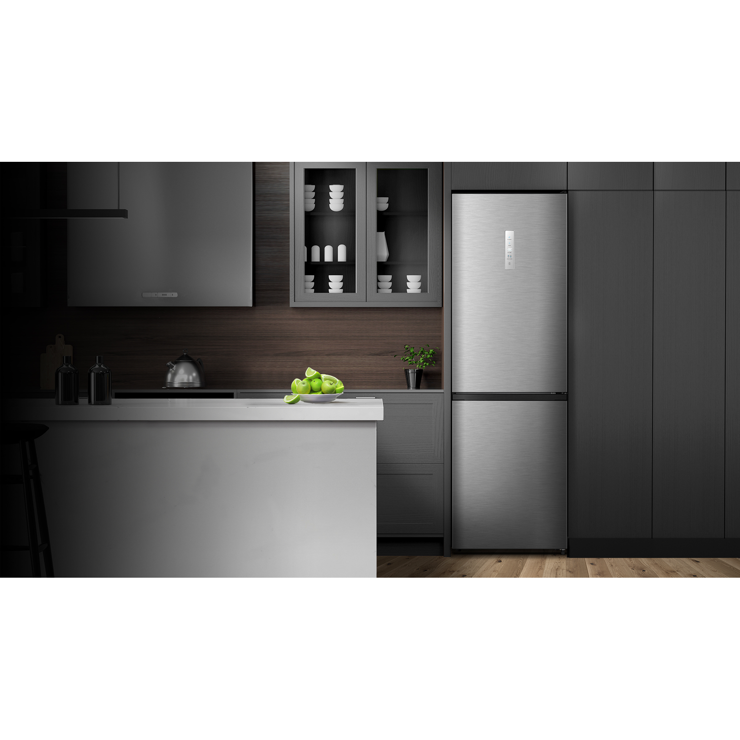 A modern kitchen with a large stainless steel refrigerator. Limes are on a counter. Dark wood cabinets. 