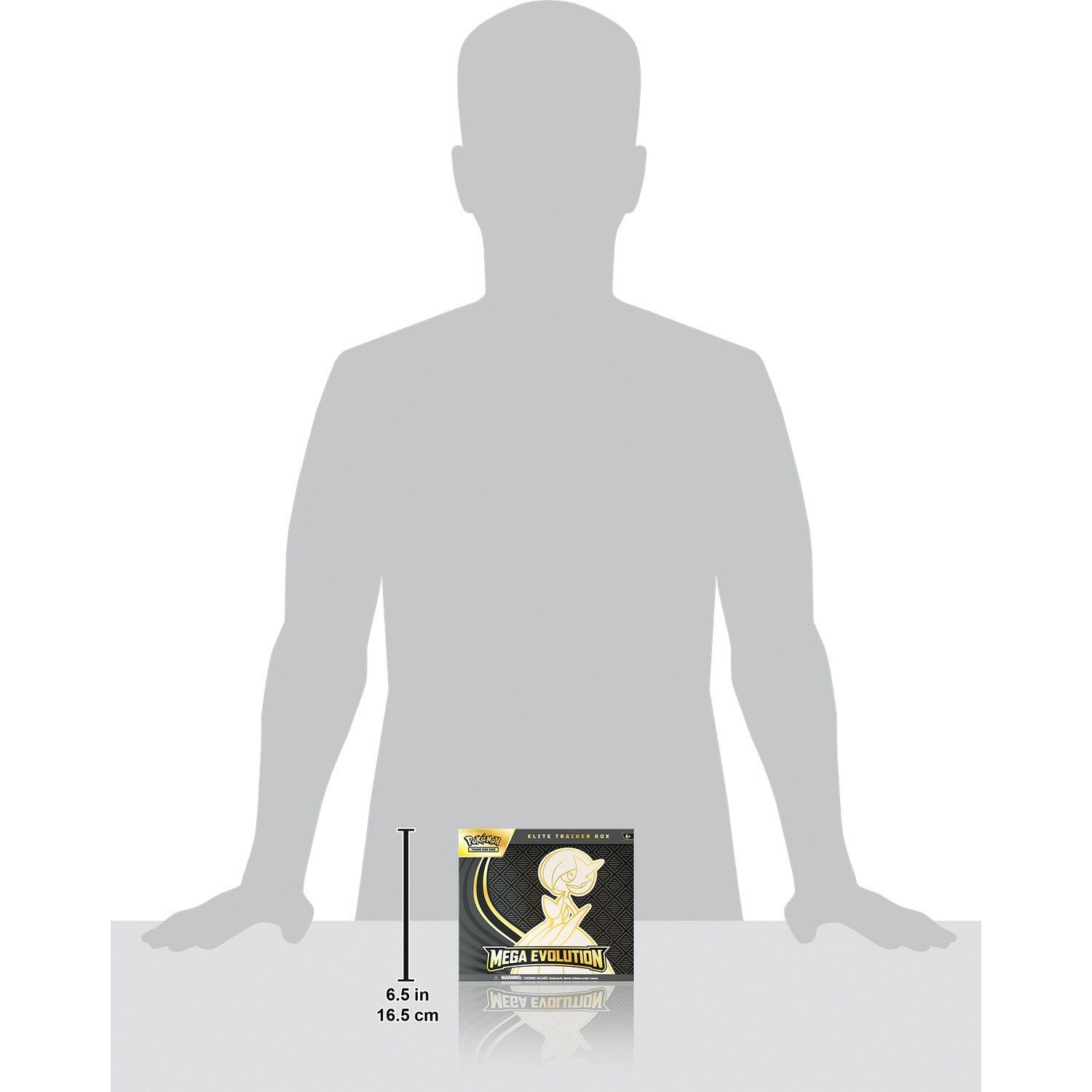 A person-shaped silhouette holds a Pokemon Mega Evolution box. The box is black and gold with a Gardevoir image. The height is 6.5 in.