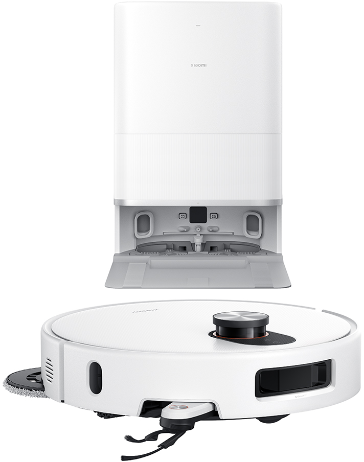 Un aspirateur robot blanc avec une station de charge. L'aspirateur a un dessus noir et un design circulaire. La station est rectangulaire.
