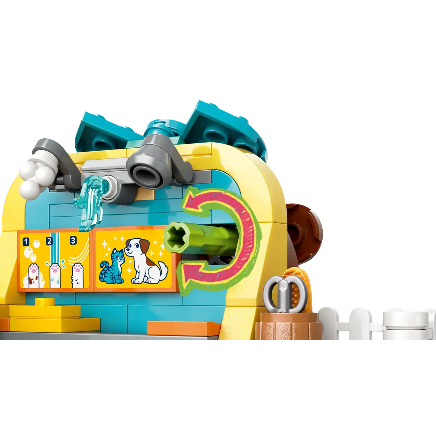 A Lego pet wash station with a dog and cat on a sign. The station is yellow and blue with a green arrow and a small white fence.