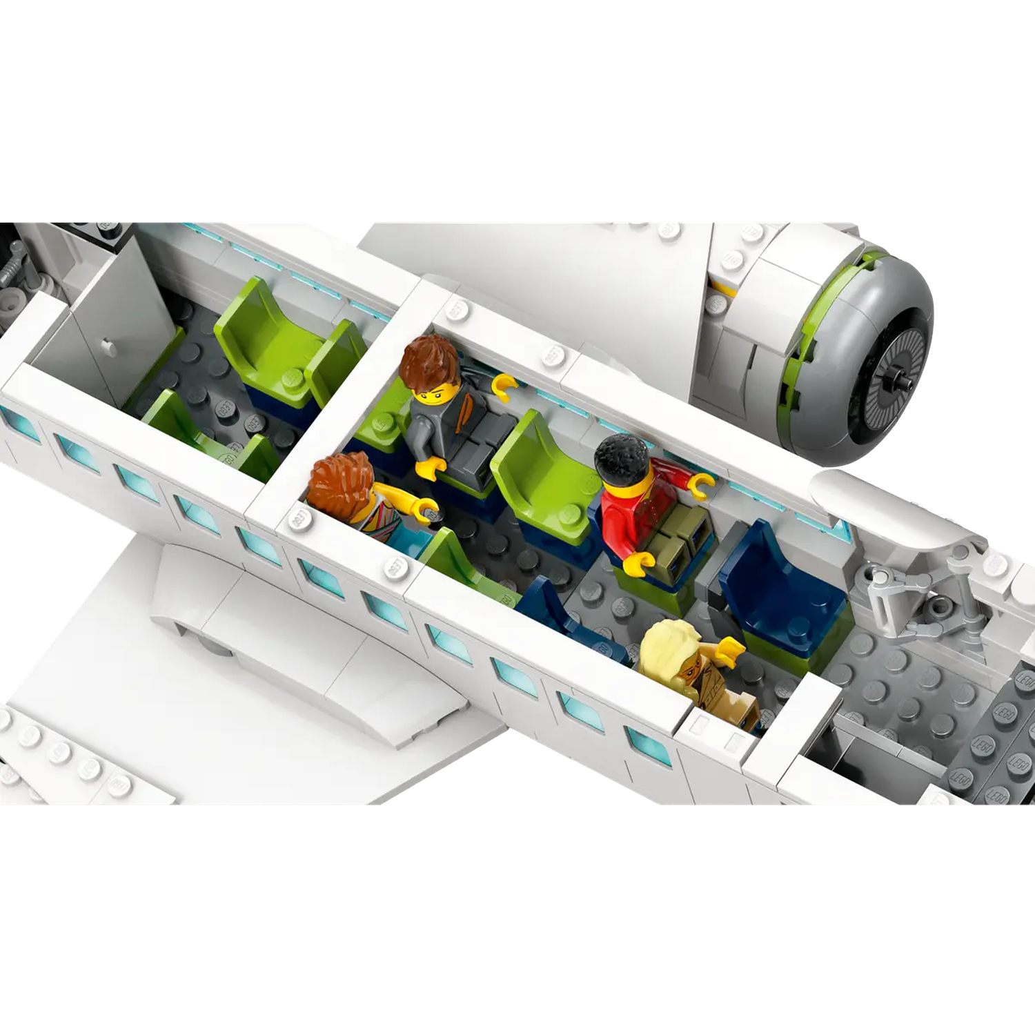 Lego airplane interior with passengers seated. Green and blue seats, white plane body. Passengers are in various colored outfits.