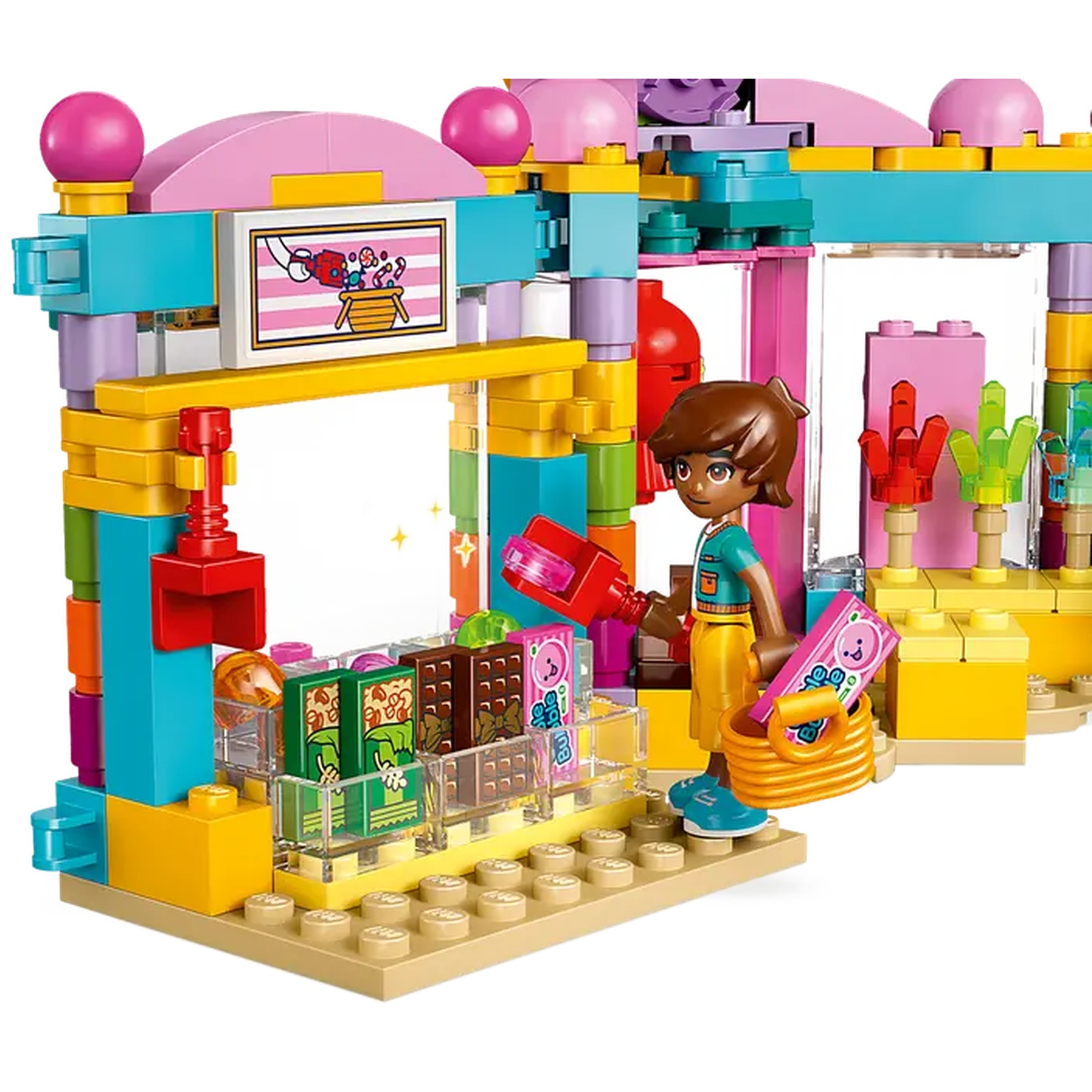 A Lego scene depicts a market stall. A figure holds a scoop and a basket. The stall has colorful blocks and displays various items.