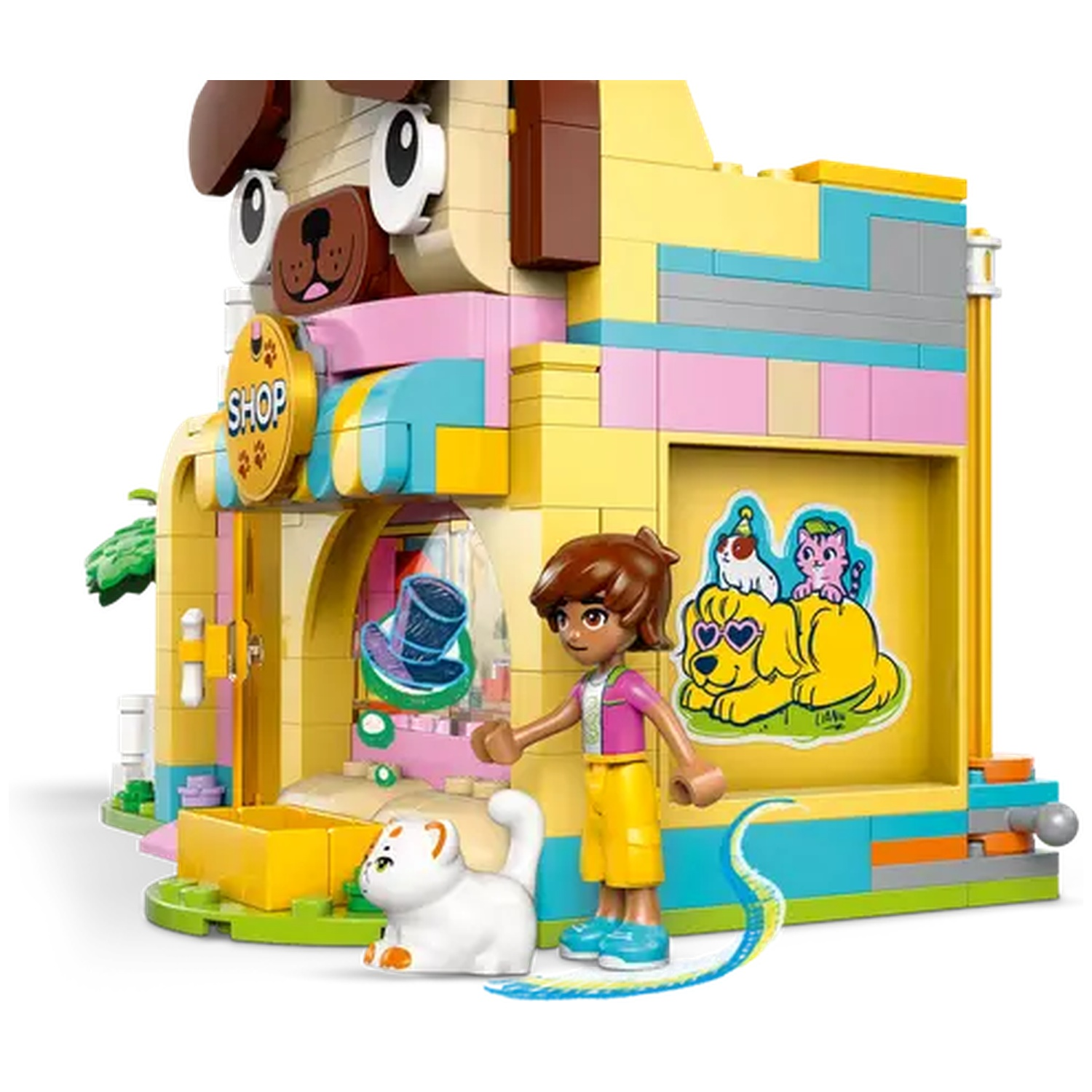 A Lego pet shop with a dog facade. A girl and a white cat are in front. The shop has a yellow sign that says 'Shop'.
