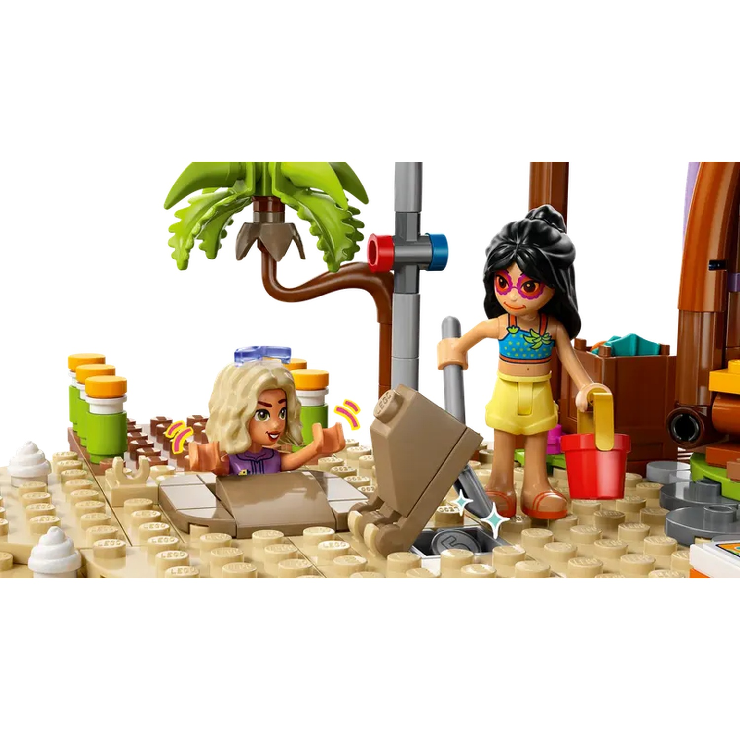 Lego scene with two figures on the beach. One figure is in a hole, the other is holding a shovel and a red bucket.