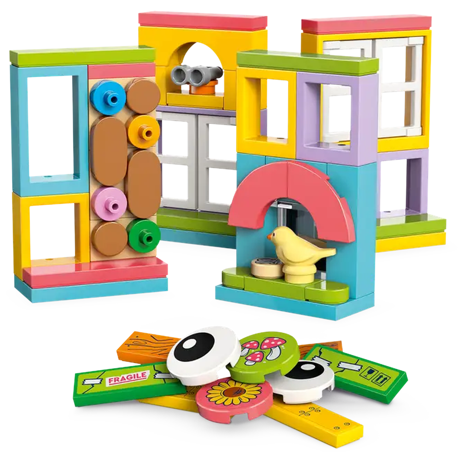 Colorful building blocks forming structures. A yellow bird sits in one. Various shapes and colors are scattered at the bottom.