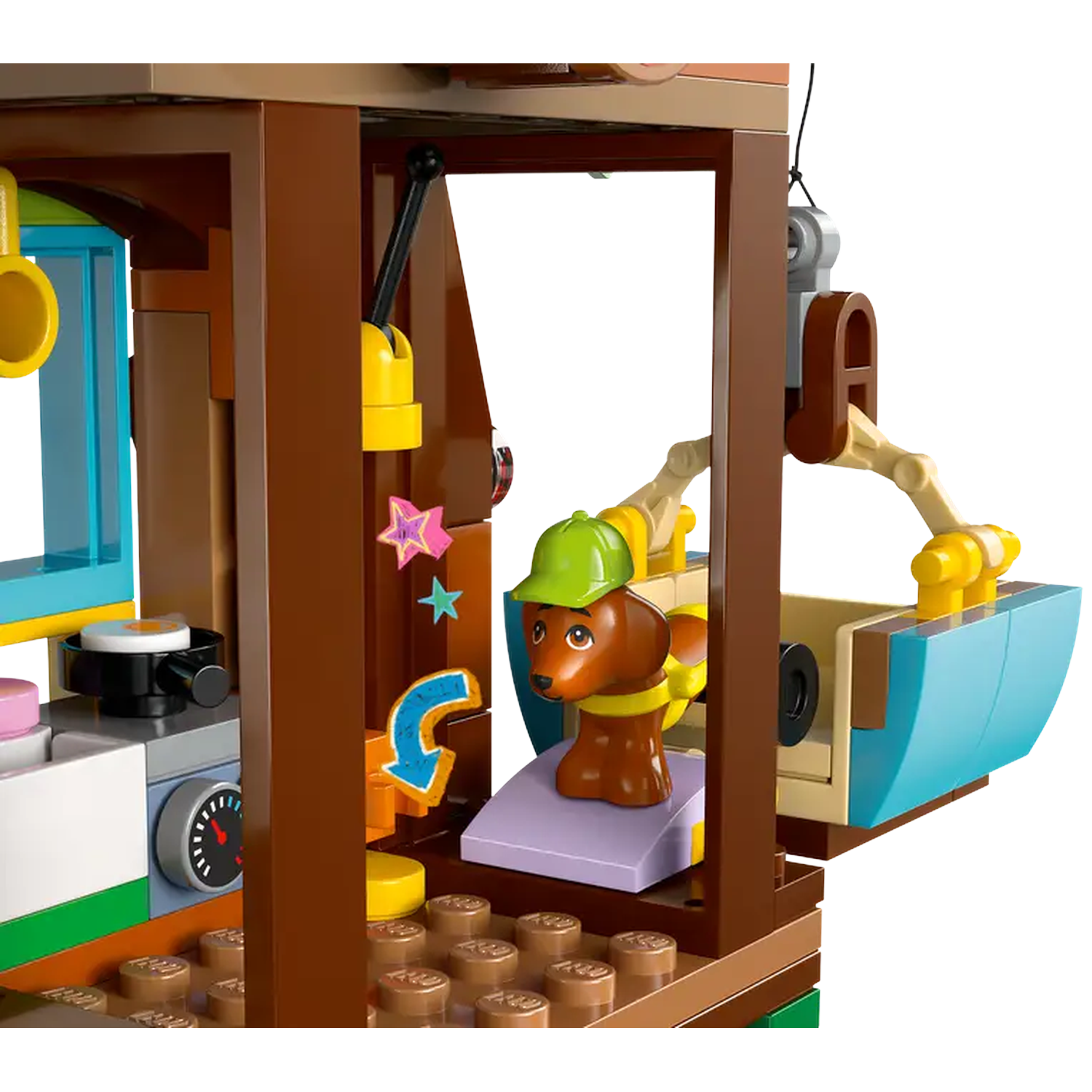 A Lego scene features a dog in a green cap. It sits in a blue basket. Brown building frame surrounds the scene with colorful elements.