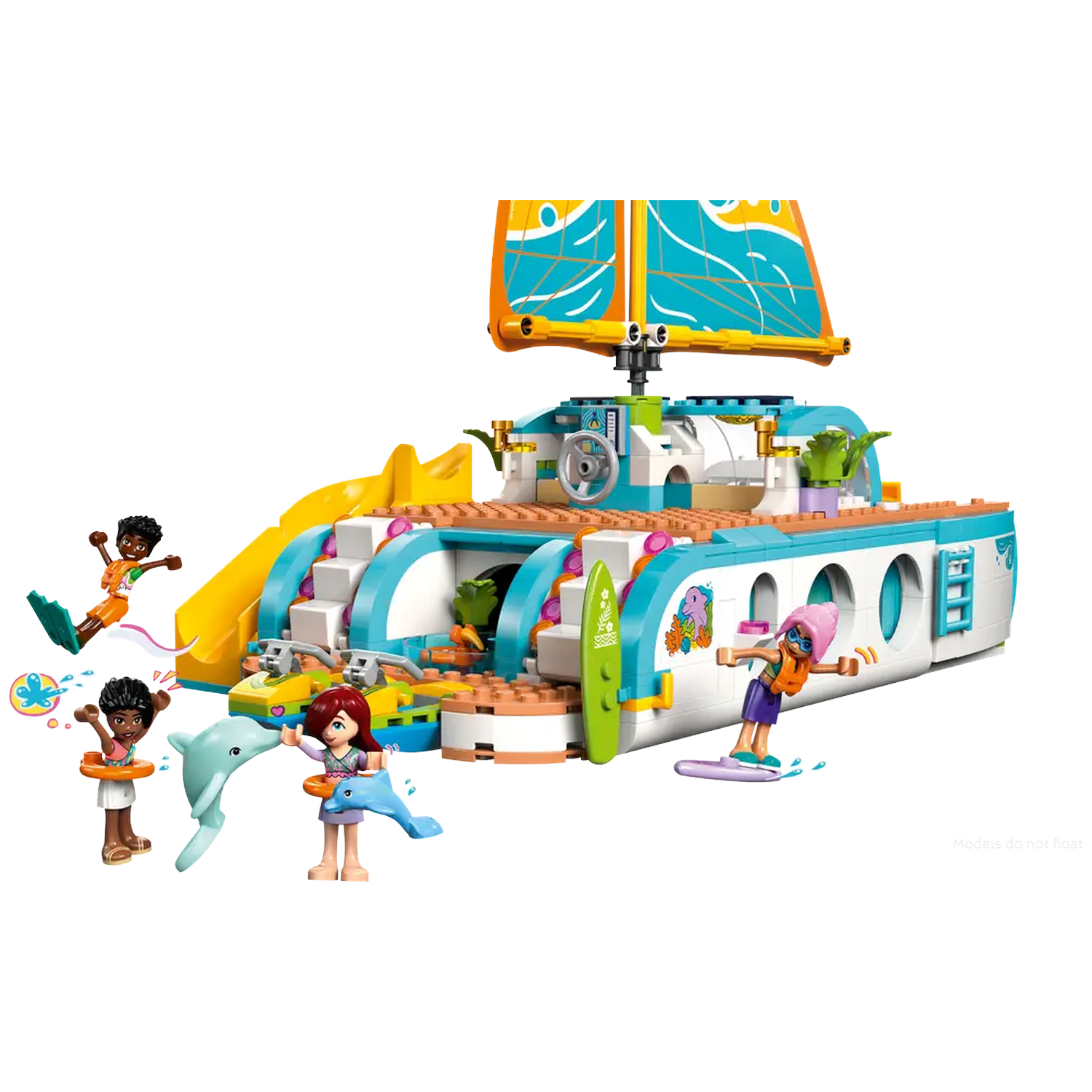 Lego catamaran with figures. Figures are swimming, surfing, and playing with dolphins. The boat has a slide and sail.